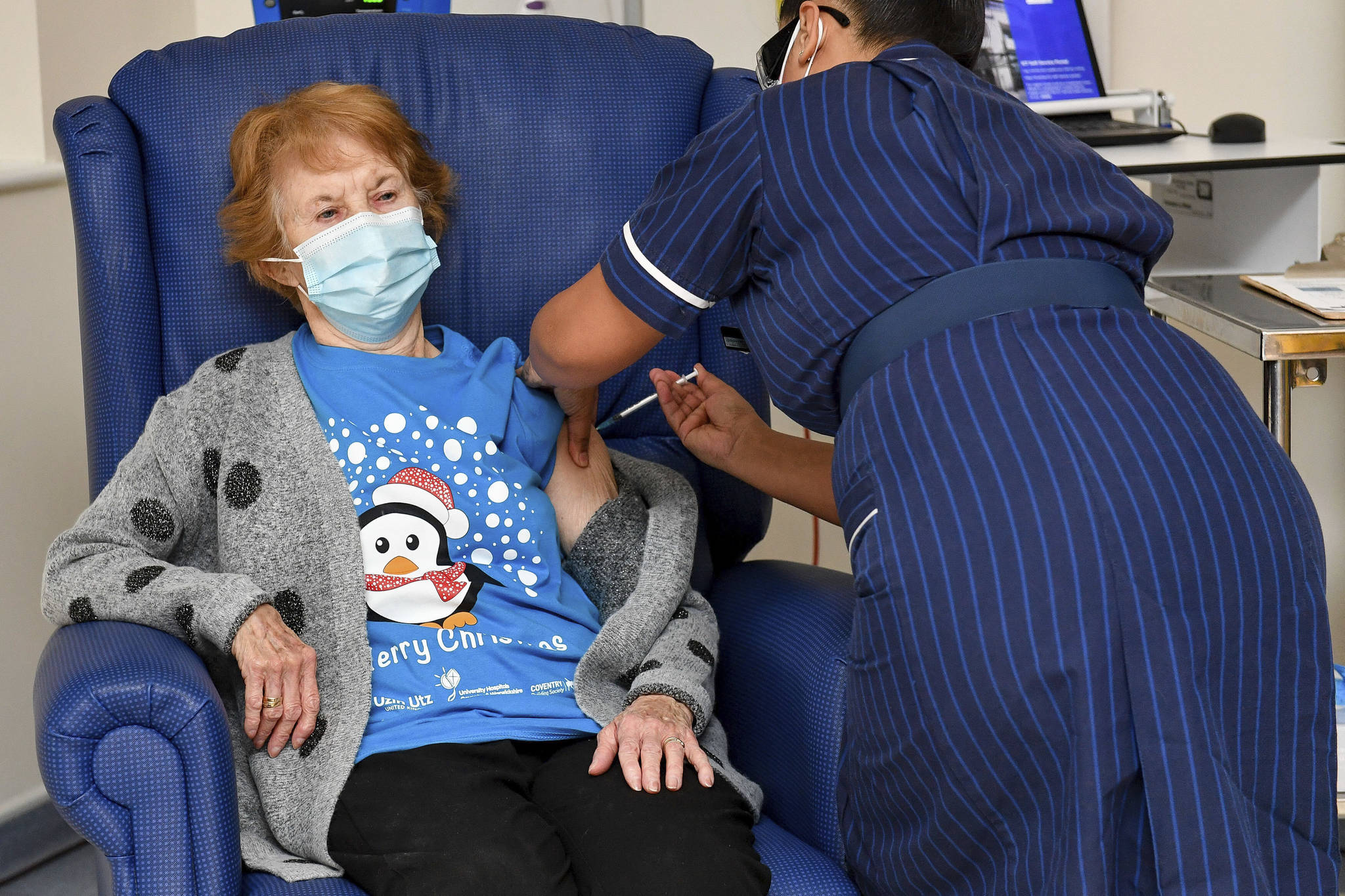 Margaret Keenan, 90, the first patient in the U.K. to receive the Pfizer-BioNTech COVID-19 vaccine, receives an injection by nurse May Parsons at University Hospital, Coventry, England. (Jacob King/Pool via AP)