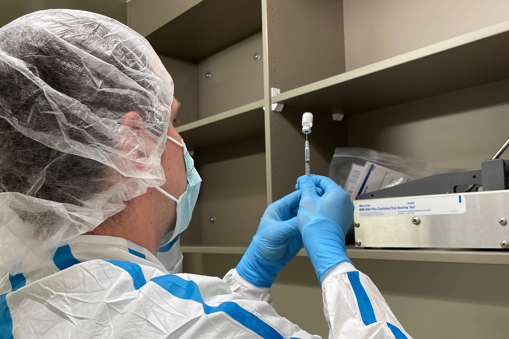 Justin Richardson, a pharmacy technician with Bartlett Regional Hospital, prepares the first dose of the Pfizer/BioNTech coronavirus vaccine on Dec. 15, 2020. (Courtesy photo / Katie Bausler)