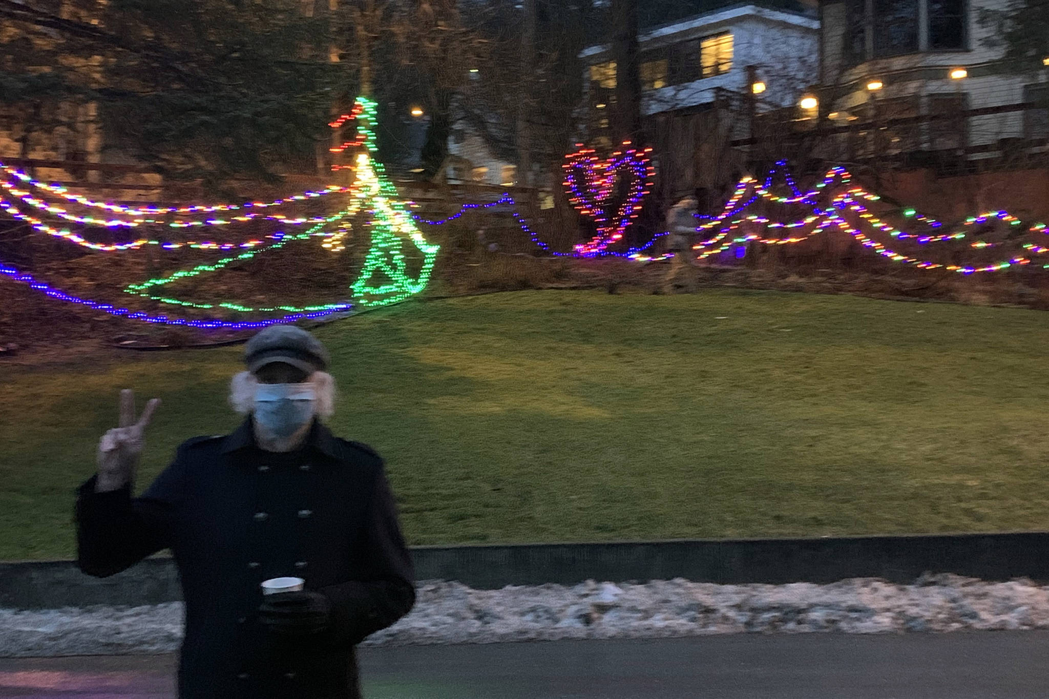 Bill Conrow, Juneau resident and long-time, free-lance stage director and light designer stands in front of a holiday light display near Juneau-Douglas City Museum. (Dana Zigmund / Juneau Empire)