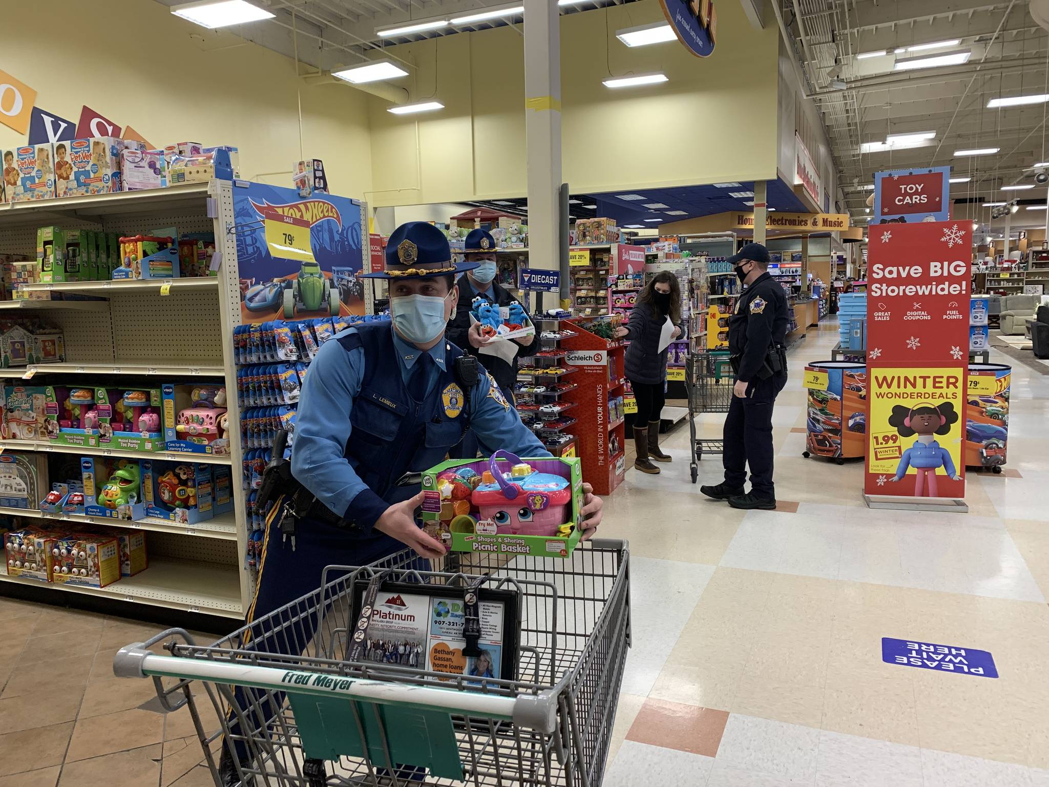 Alaska State Troopers shop for Juneau families at Fred Meyer on Dec. 21, 2020 as part of the Alaska Police Officer Association’s annual “Shop with a Cop” event for Christmas. (Courtesy photo / Alaska State Troopers)