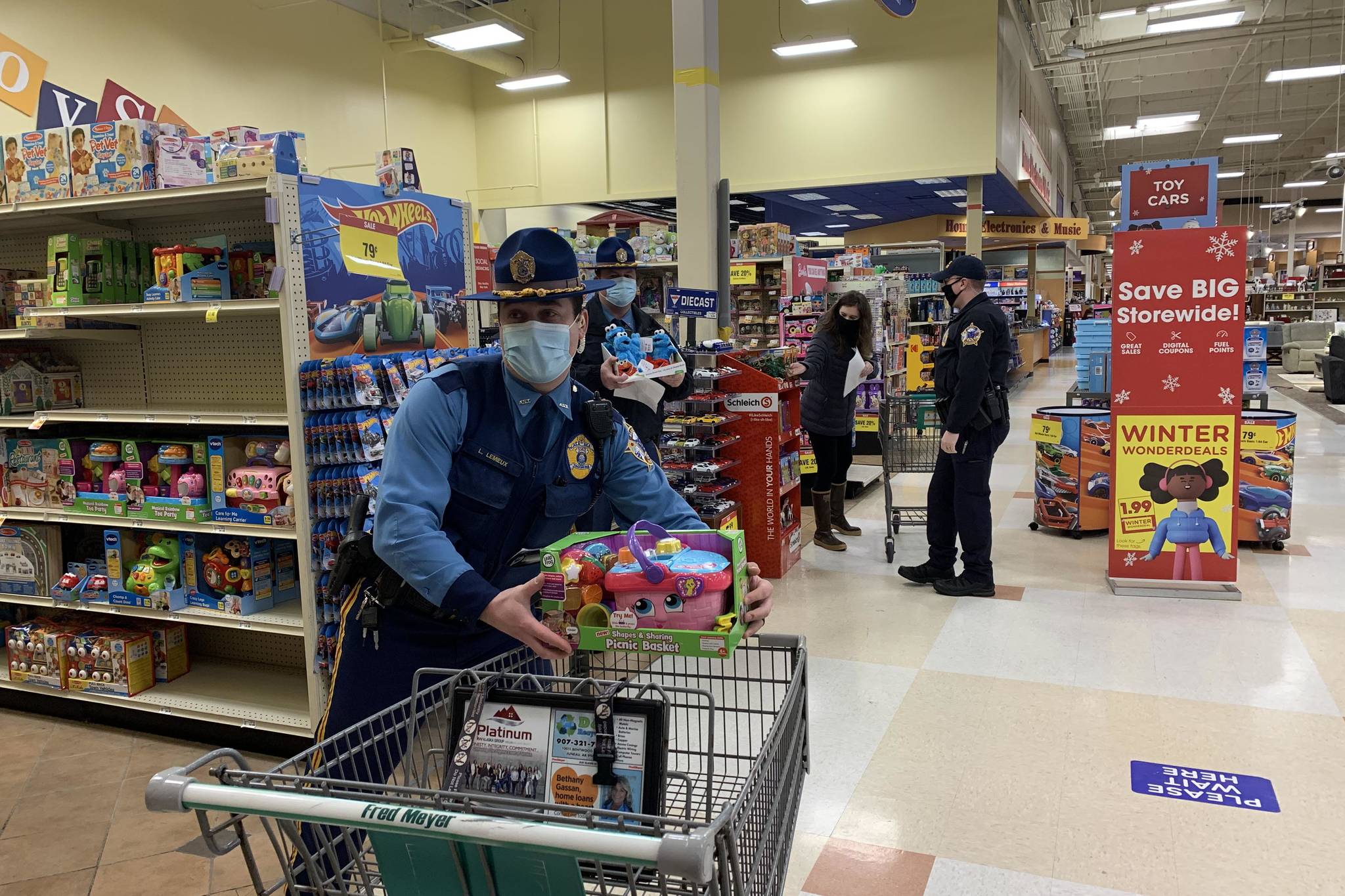Courtesy photo / Alaska State Troopers
Alaska State Troopers shop for Juneau families at Fred Meyer on Dec. 21 as part of the Alaska Police Officer Association’s annual “Shop with a Cop” event.