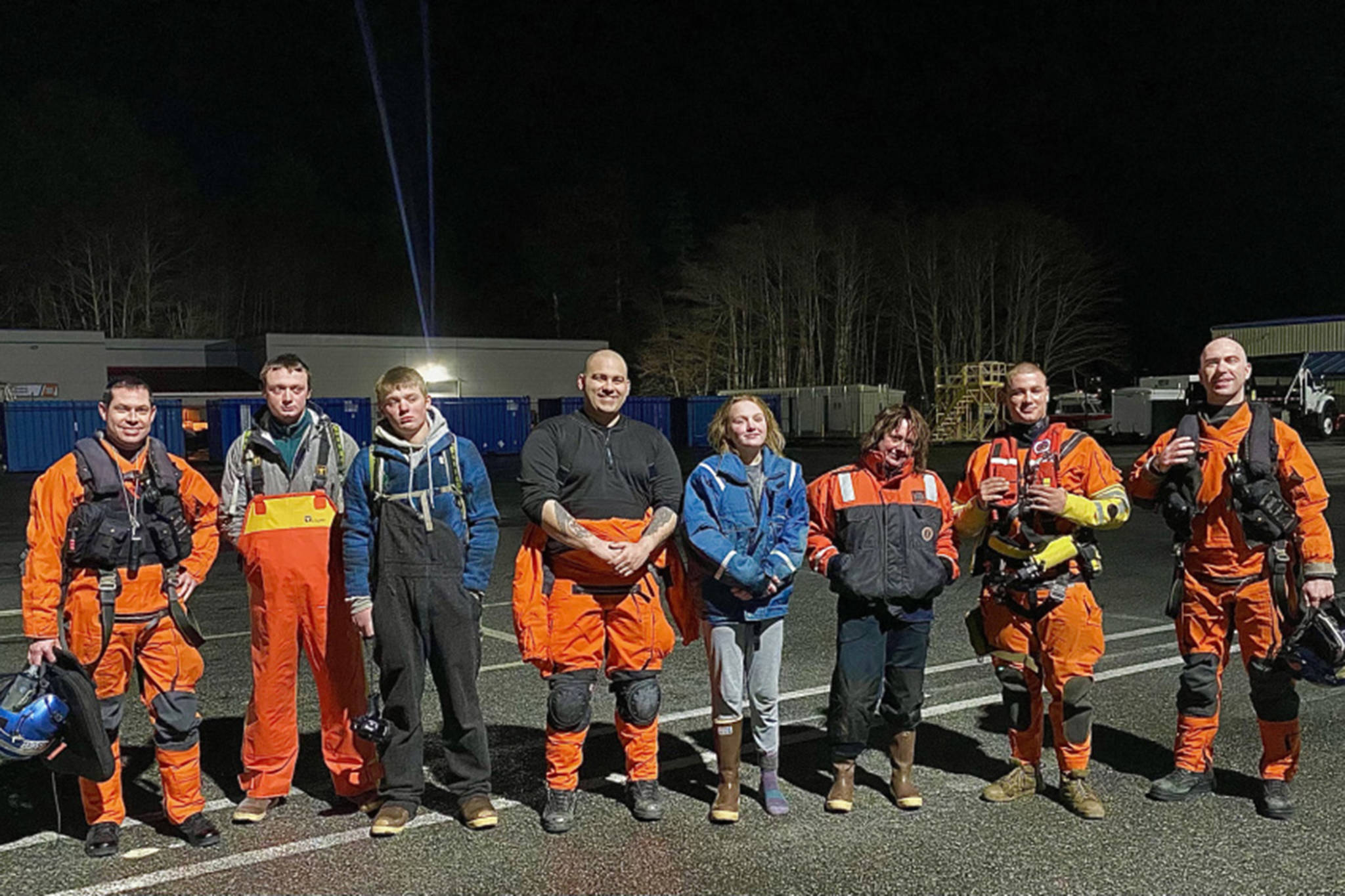 An MH-60 Jayhawk helicopter crew from Air Station Sitka pose with the family they rescued about an hour earlier from Yamani Islets, Dec. 25, 2020. The aircrew hoisted all four family members to safety after their boat capsized. (Courtesy Photo / Coast Guard Air Station Sitka)