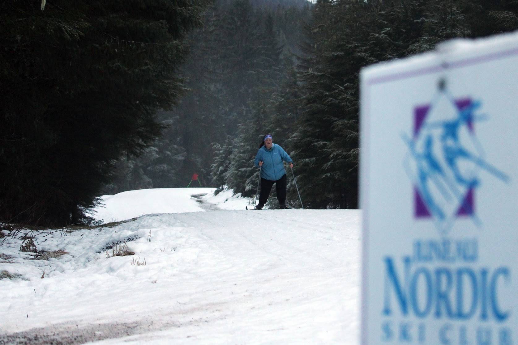 Allison Smith, a member of the Juneau Nordic Ski Club, passes another skier on her way along Montana Creek Road. Ski trails around Juneau will soon be hiding clues for Juneau Nordic Ski Club’s ski-o’cache event. (Ben Hohenstatt/Juneau Empire)