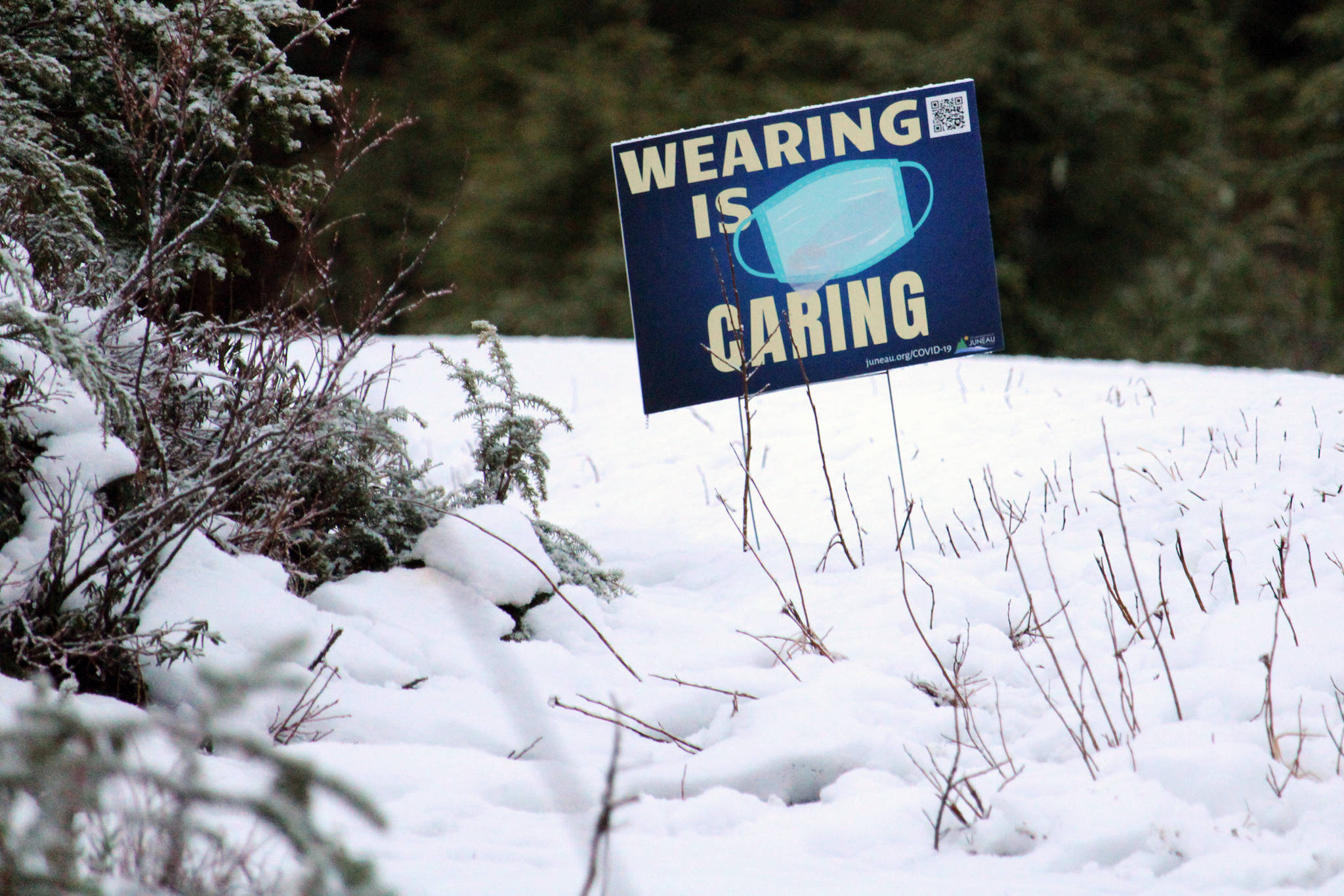 A sign along Montana Creek Road encourages Juneau residents to wear face masks in public settings on Dec. 29. (Ben Hohenstatt / Juneau Empire)