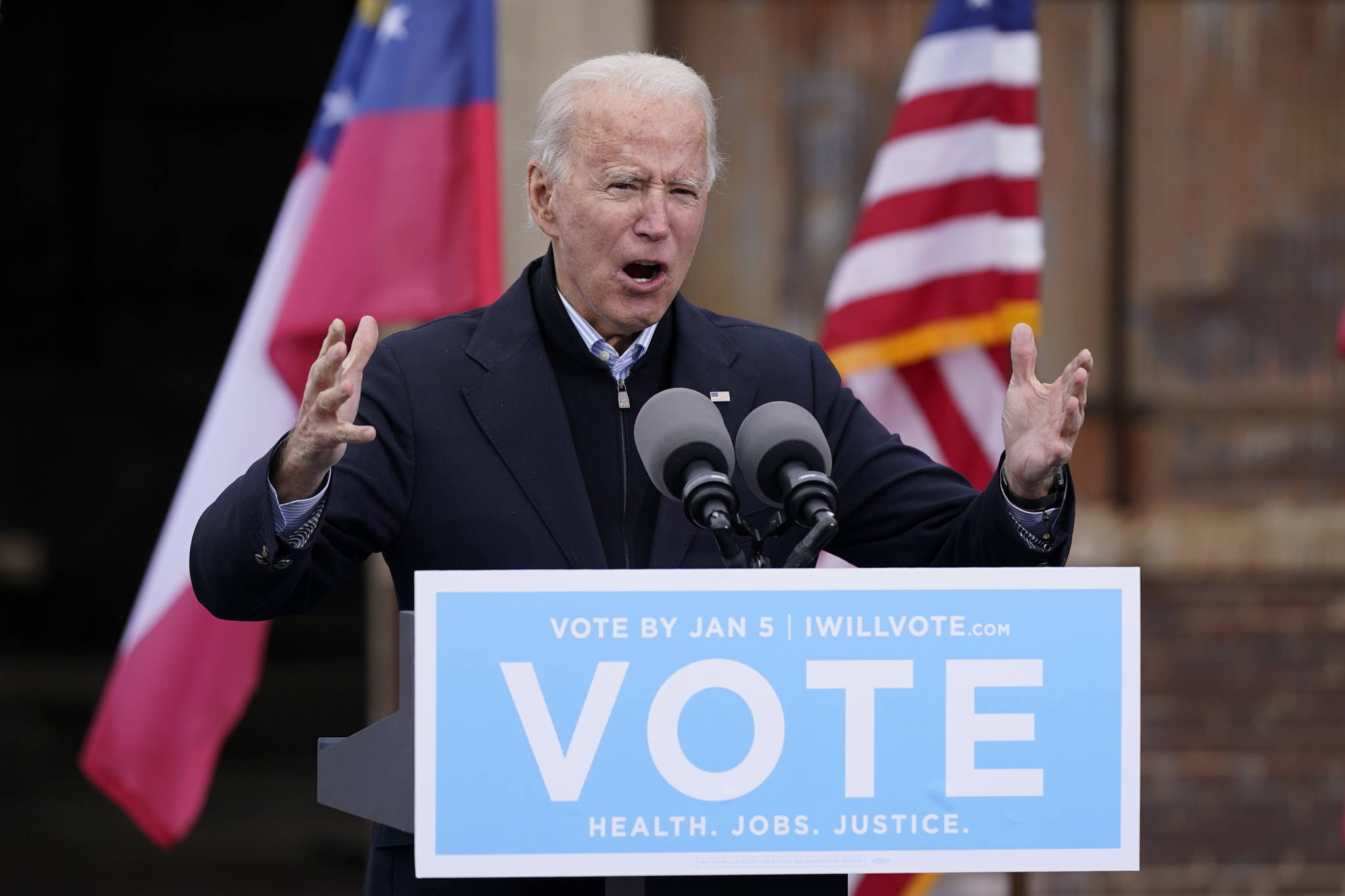 President-elect Joe Biden speaks at a drive-in rally for Georgia Democratic candidates for U.S. Senate Raphael Warnock and Jon Ossoff, in Atlanta. The first full week of 2021 is shaping up to be one of the biggest of Biden’s presidency. And he hasn’t even taken office yet. (AP Photo/Patrick Semansky, File)