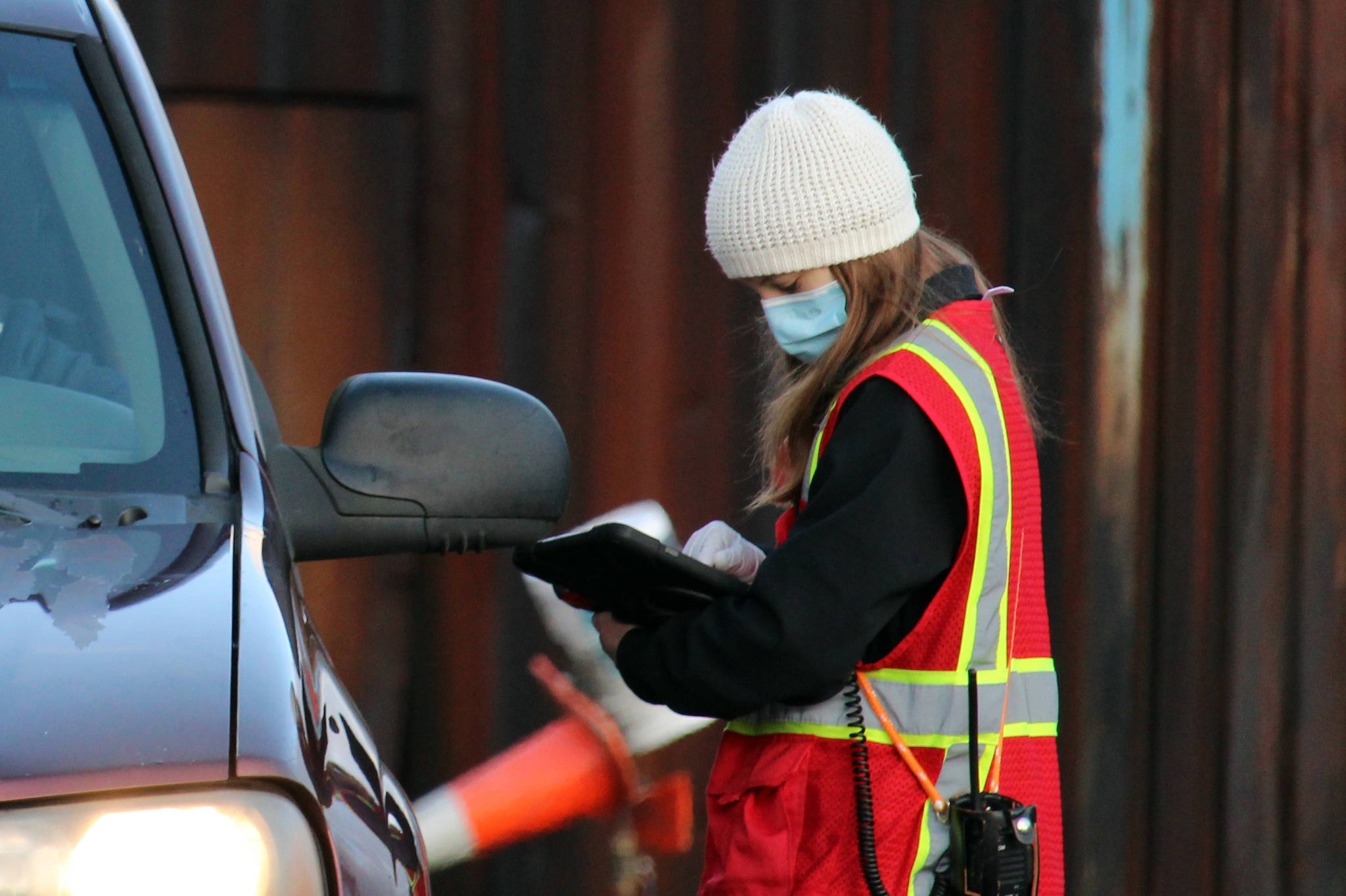 Abby Jones, an emergency worker for Capital City Fire/Rescue, checks in a Juneau resident for free asymptomatic testing on Dec. 31, 2021. (Ben Hohenstatt / Juneau Empire)
