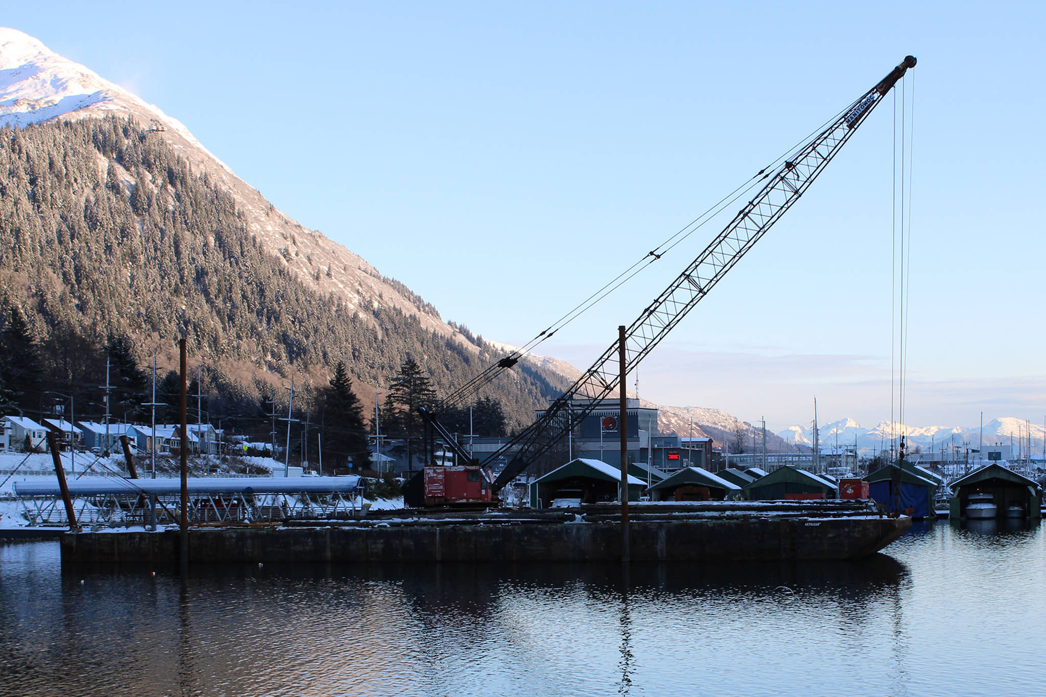 Ben Hohenstatt / Juneau Empire File 
A crane sits in the city-owned Aurora Harbor on Nov. 6, there for a project to repair the docks. The construction industry was one of the few in Southeast which wasn’t dramatically impacted by the COVID-19 pandemic according to state economists.