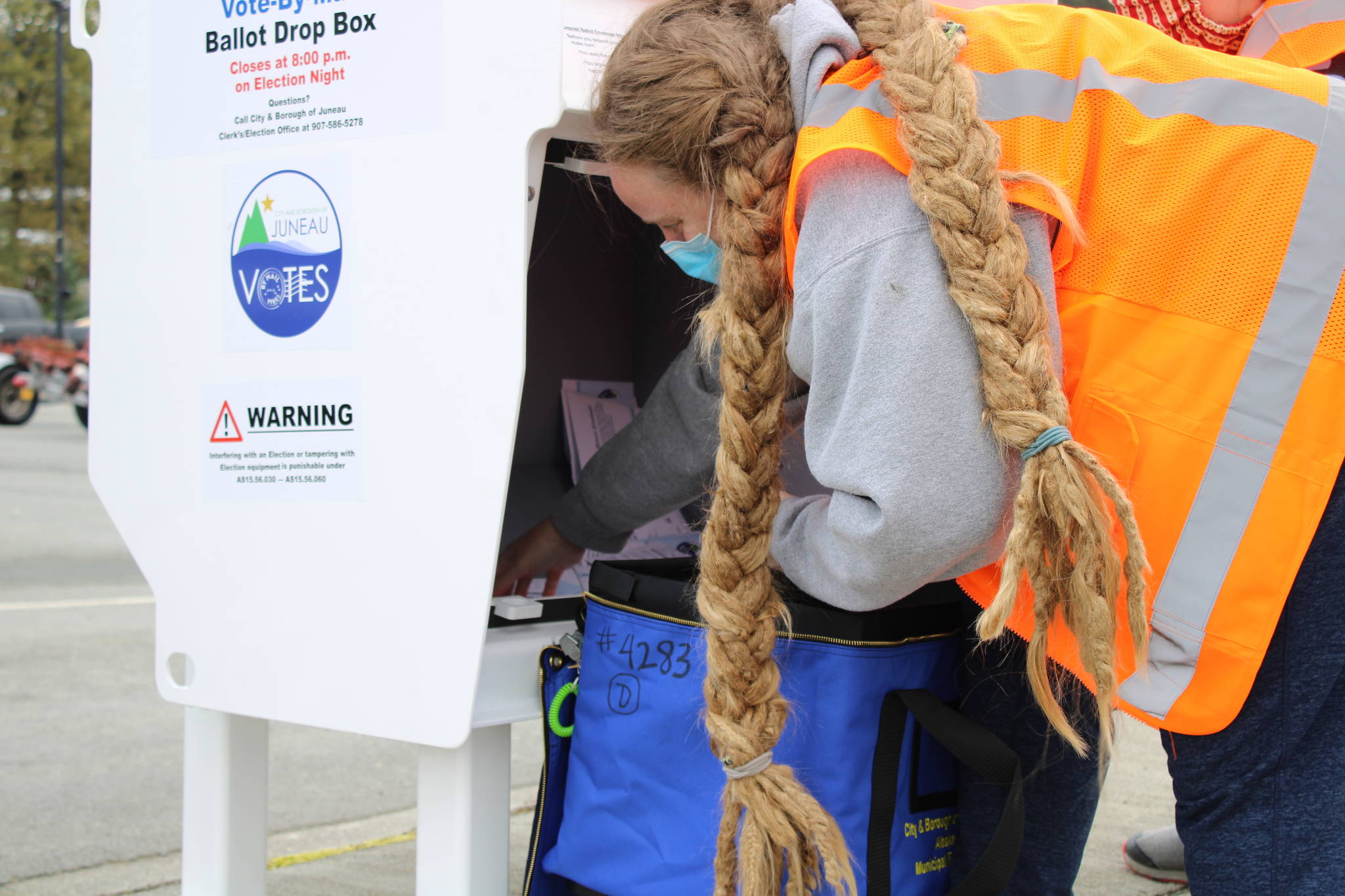 Deputy City Clerk Di Cathcart collects ballots from the ballot drop box at Don D. Statter Harbor the afternoon of Saturday, Sept. 19. Ballot drop boxes could factor into future municipal elections, too, depending on direction from the assembly. (Ben Hohenstatt / Juneau Empire)