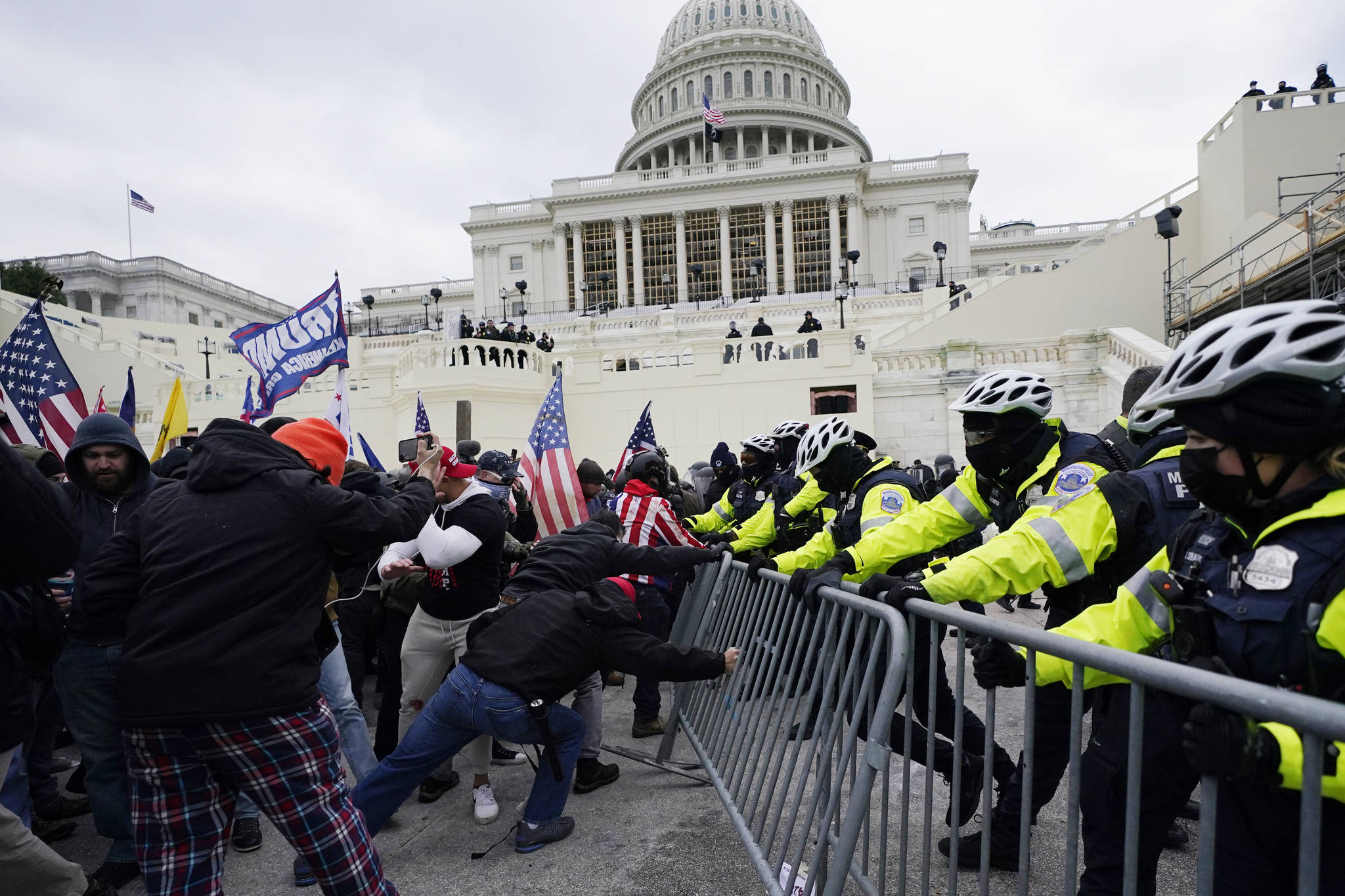 Trump supporters try to break through a police barrier, Wednesday, Jan. 6, 2021, at the Capitol in Washington. As Congress prepares to affirm President-elect Joe Biden’s victory, thousands of people have gathered to show their support for President Donald Trump and his claims of election fraud. (AP Photo / Julio Cortez)