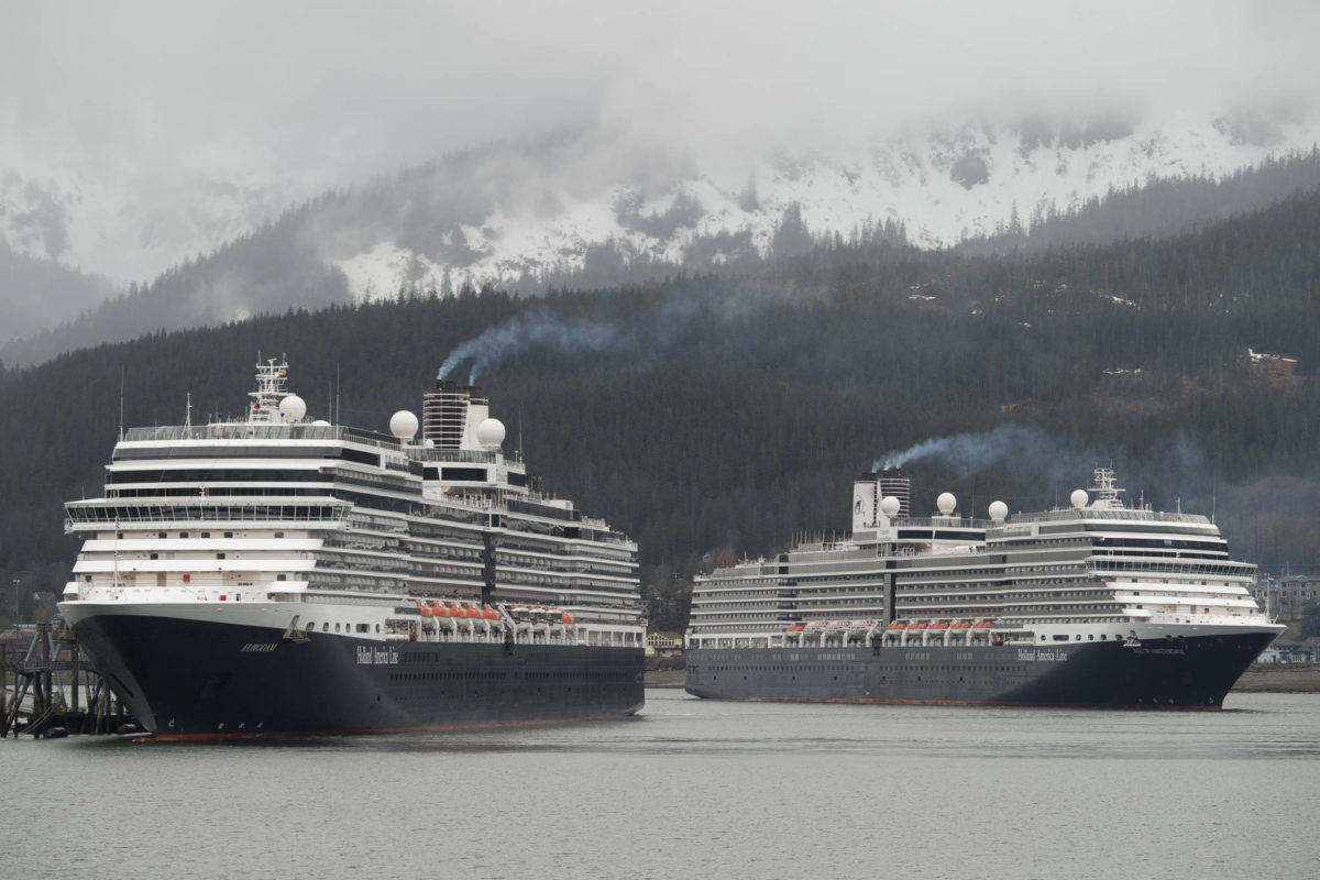 The Holland America Line cruise ships Eurodam, left, and Nieuw Amsterdam pull into Juneau’s downtown harbor on May 1, 2017. Holland America extended its pause on sailings to Alaska until mid-May as the company tries to find ways to sail under new health regulations. (Michael Penn / Juneau Empire File)