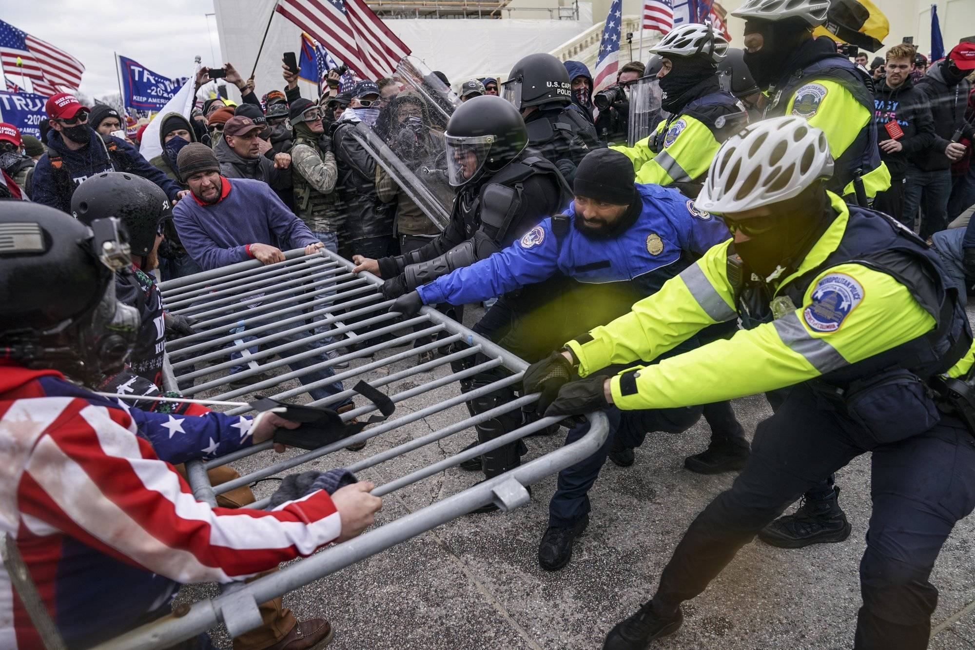Trump supporters try to break through a police barrier, Wednesday, Jan. 6, 2021, at the Capitol in Washington. (AP Photo/John Minchillo)