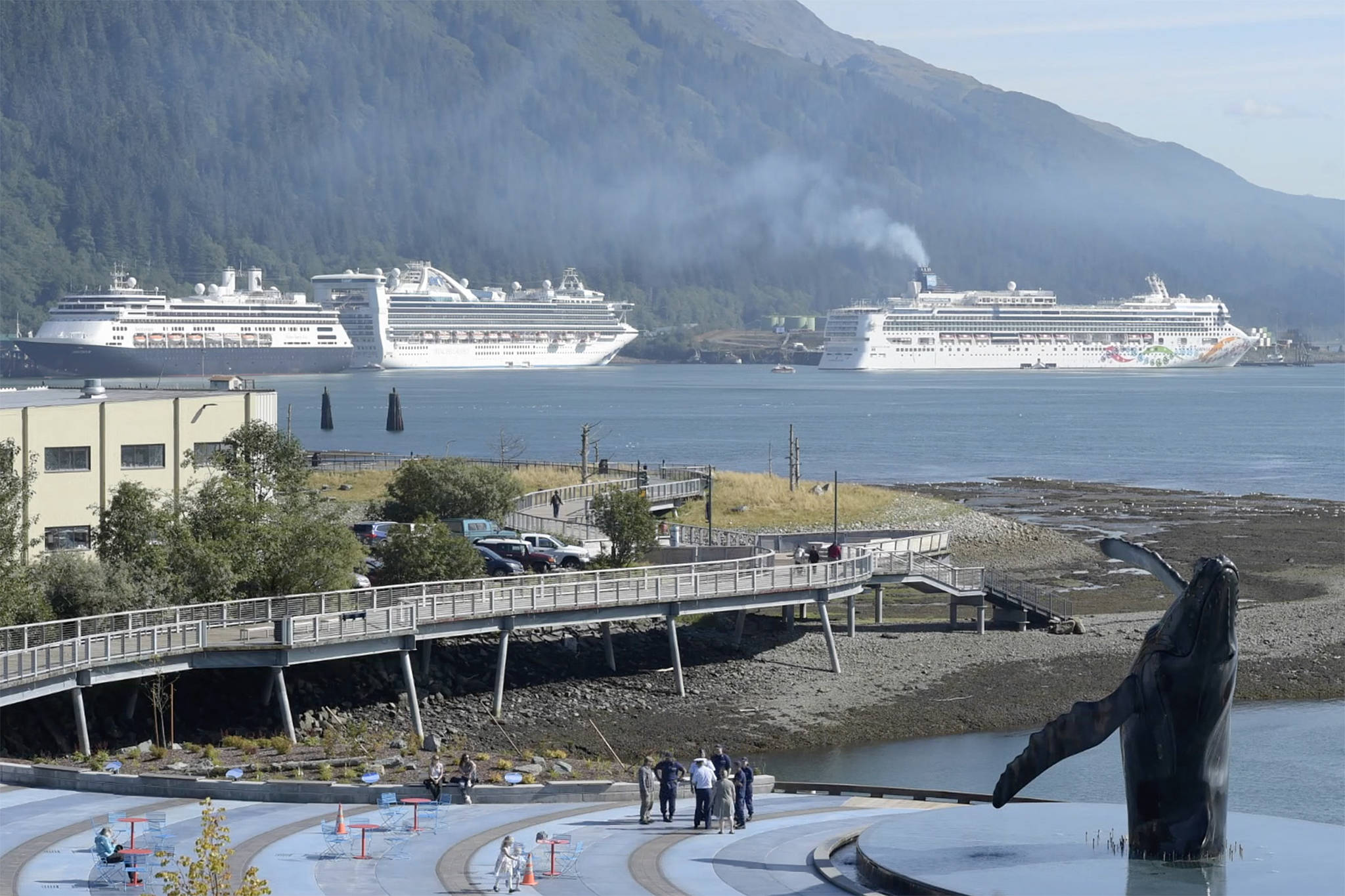 City leaders are waiting to learn more about the City and Borough of Juneau’s protocols that allow cruise ships to resume sailing. The Norwegian Pearl cruise ship, right, pulls into the AJ Dock in Juneau in September 2018. (Michael Penn | Juneau Empire)