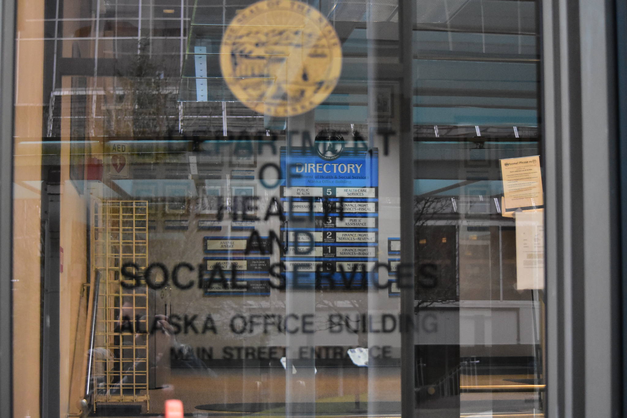 The entrance to the Alaska Department of Health and Social Services building in downtown Juneau. Gov. Mike Dunleavy has proposed splitting the department to spread the administrative burden, but health care workers and tribal leaders say they weren’t consulted and Alaska Natives will likely be negatively impacted. (Peter Segall / Juneau Empire)