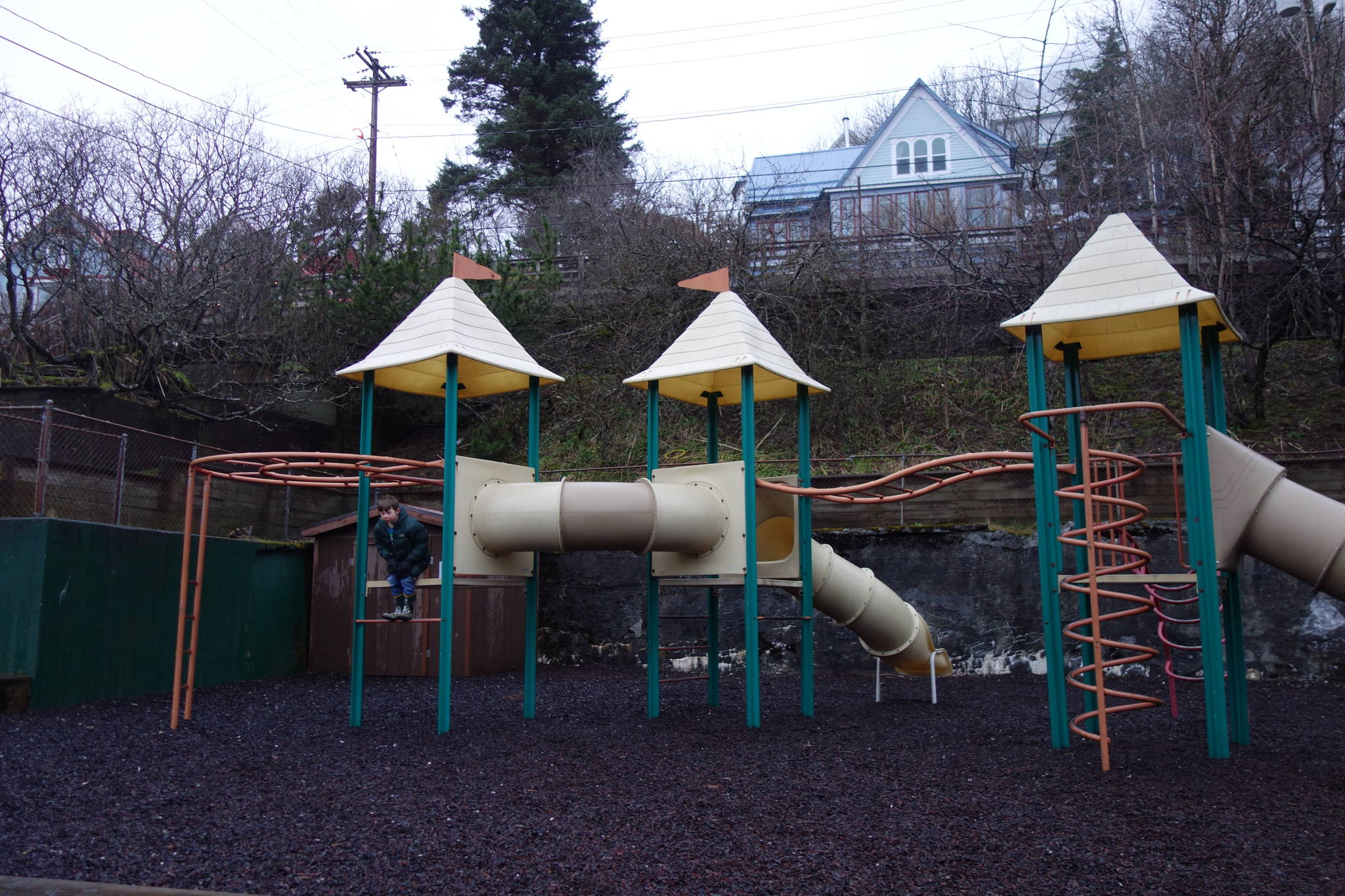 A child plays at Capital School Park. The park is in line for a remodel that will fix the crumbling retaining wall, visible in the background. (Dana Zigmund / Juneau Empire)