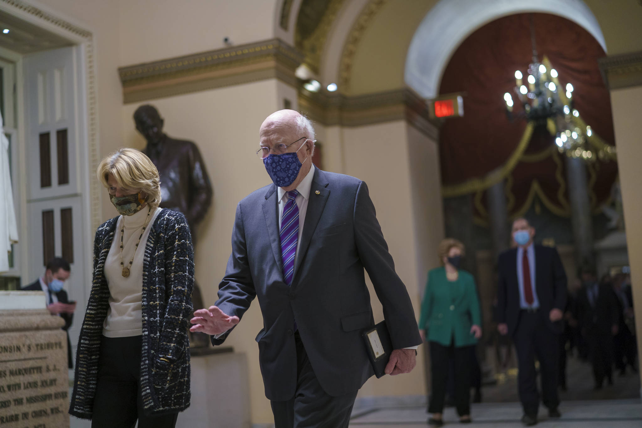 U.S. Sen. Lisa Murkowski, R-Alaska, left, and Sen. Patrick Leahy, D-Vermont, join other senators as they return to the House chamber to continue a joint session of the House and Senate and count the Electoral College votes on Jan. 6. (AP Photo/J. Scott Applewhite)