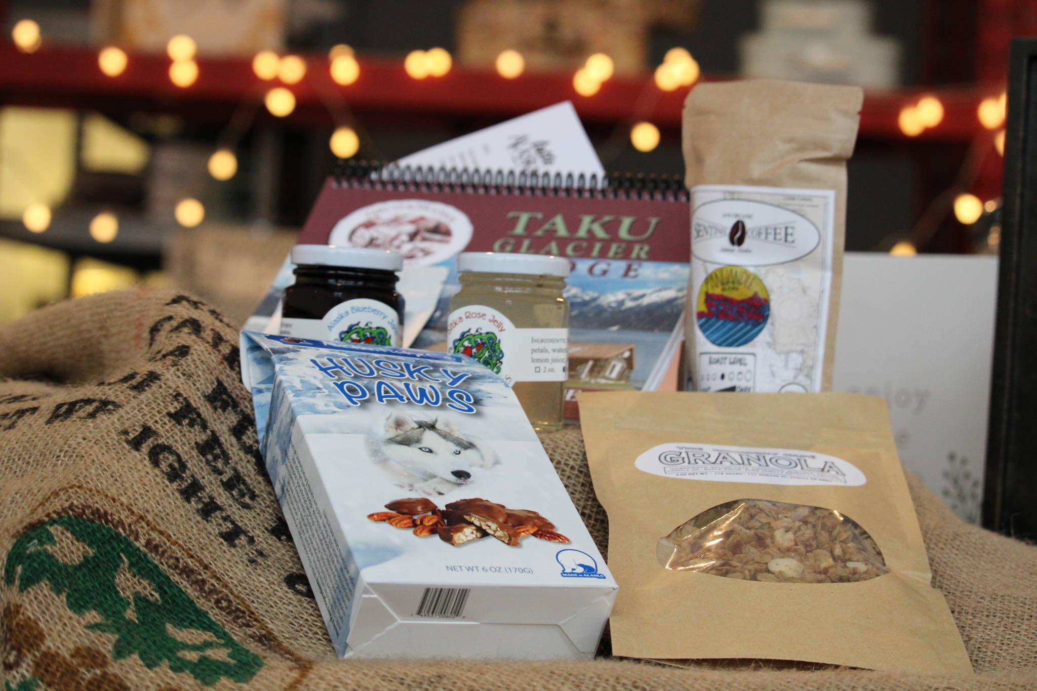 A collection of items that can be included inside a Taste Alaska! box sit on top of a table inside Juneau Food Tours on Saturday, Jan. 23. (Ben Hohenstatt / Juneau Empire)