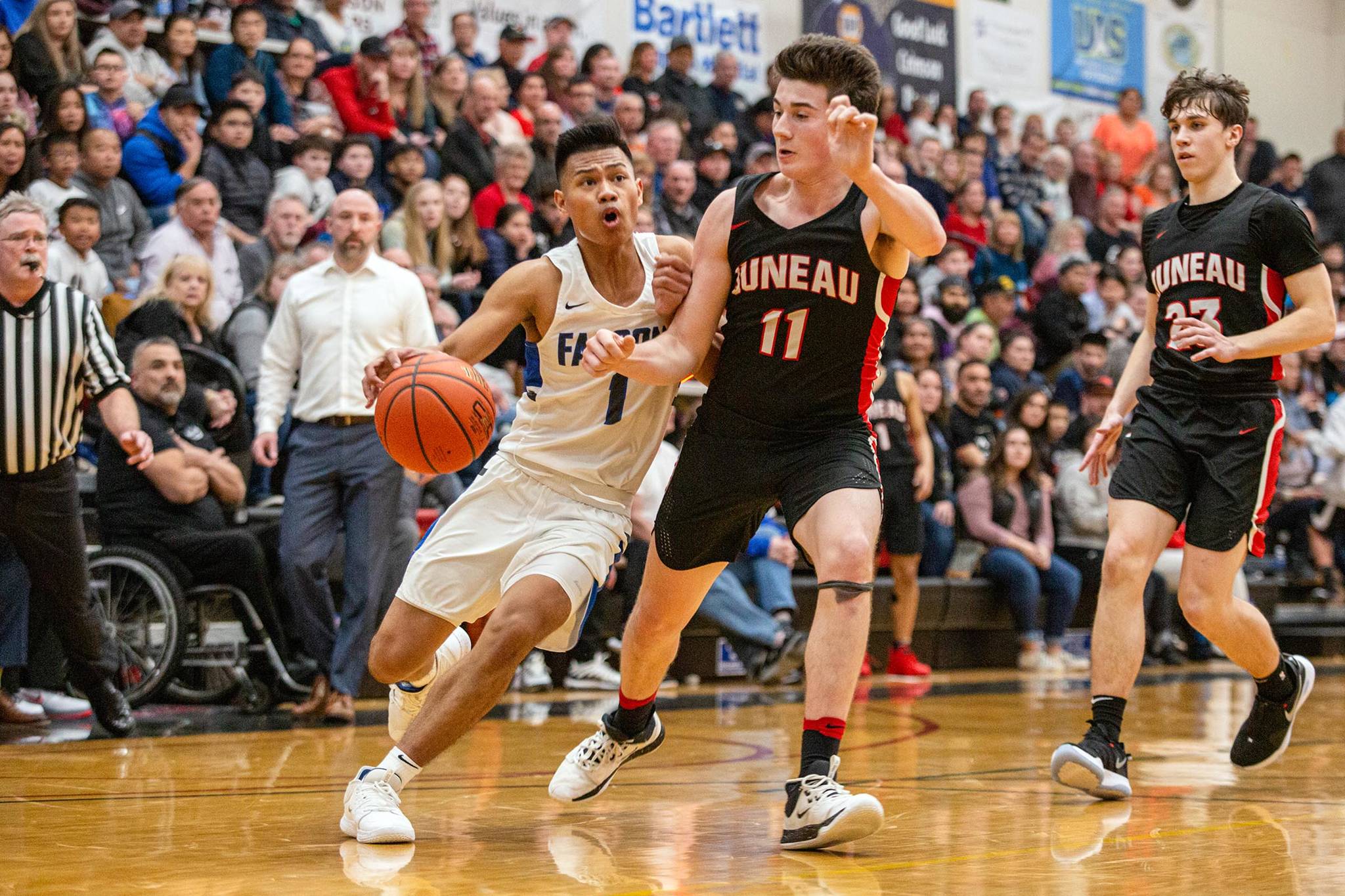 Thunder Montain High School player Brady Carandang makes his way down court while defended by Juneau-Douglas High School Yadaa.at Kalé players Garrett Bryant and Cooper Kriegmont in 2020. Kriegmont, now a senior, scored his 1,000th point on Saturday, Jan. 23, 2021. (Courtesy Photo | Heather Holt)