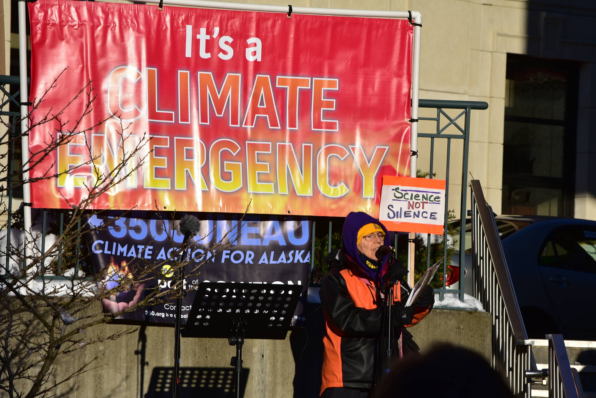 Peter Segall / Juneau Empire 
Juneau poet Lynn Davis reads a poem Tuesday at a demonstration in Dimond Court Plaza across from the Alaska State Capitol. Dozens of protestors gathered to support strong actions by the state to combat climate change.