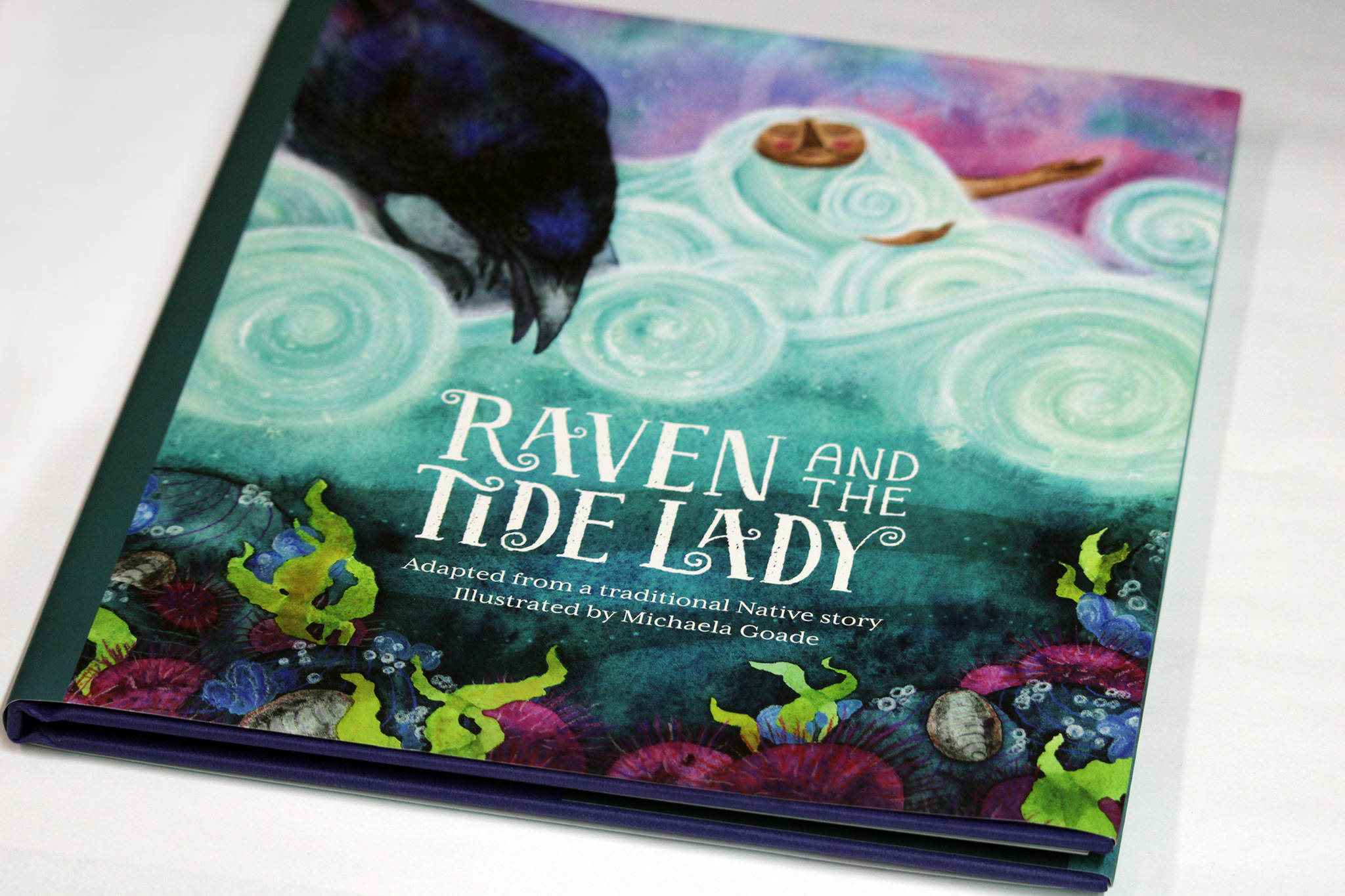 This photo shows the cover of “Raven and the Tide Lady,” which was illustrated by Michaela Goade. It is part of Sealasha Heritage Institute’s Baby Raven Reads series of books. The Baby Raven Reads program helped Michaela Goade, who is now a Caldecott Medal winner, get started in illustrating children’s books, the artist said during an interview with the Empire. (Ben Hohenstatt / Juneau Empire)