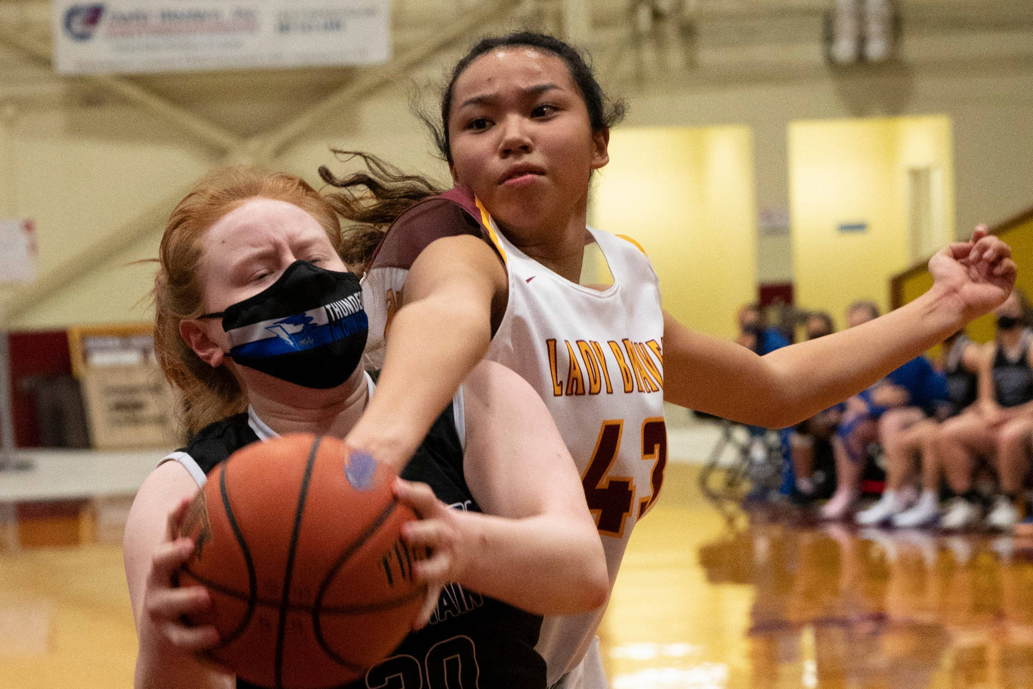 Thunder Mountain High School player Mackenzie Gray, left, competes with Mt. Edgecumbe High Schoool in Sitka on Saturday, Feb. 6, 2021. (Sitka Sentinel / James Poulson)