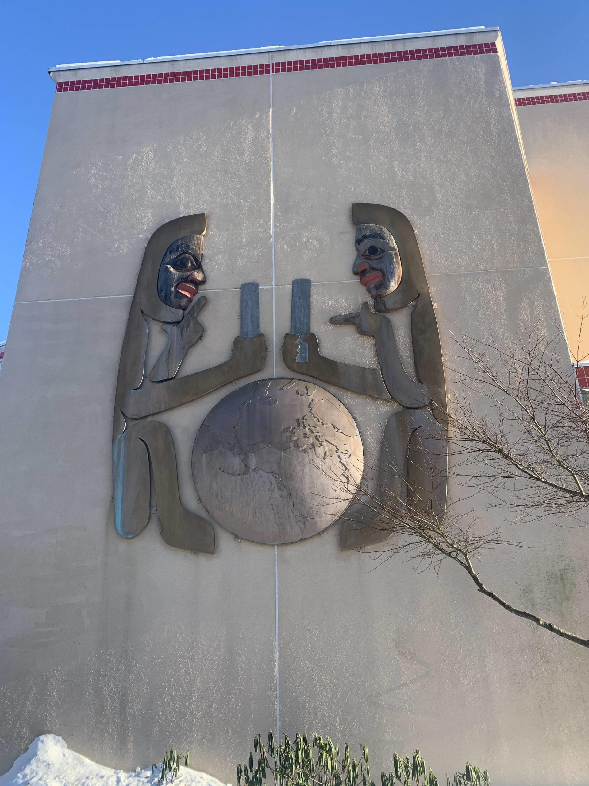 Examples of Nathan Jackson’s art appear on the Juneau Empire office building. This hanging sculpture was created in 1986 and is modeled after a set of twins in Jackson’s family. He explained that the twins often did things that were controversial, just like the world is often controversial. (Dana Zigmund/Juneau Empire)