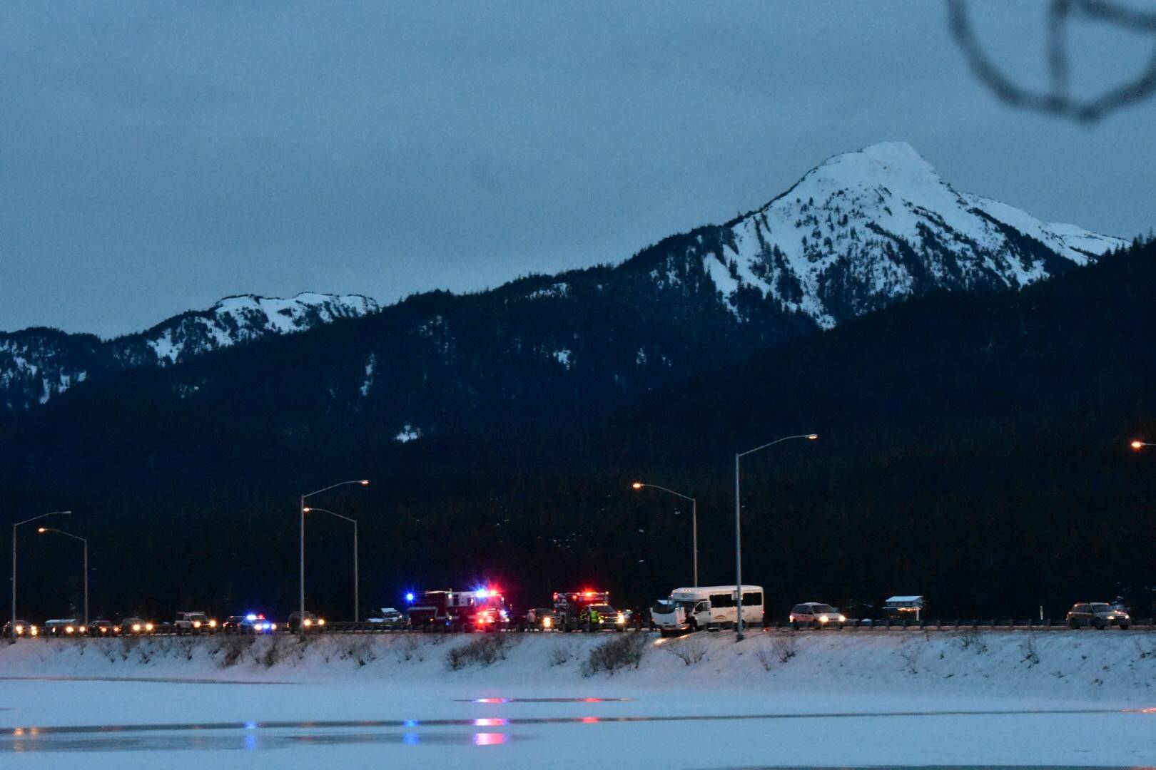 A Juneau Tours minibus crashed into a guardrail on Egan Drive near Twin Lakes for reasons unknown on Feb. 15, 2021. (Peter Segall / Juneau Empire)