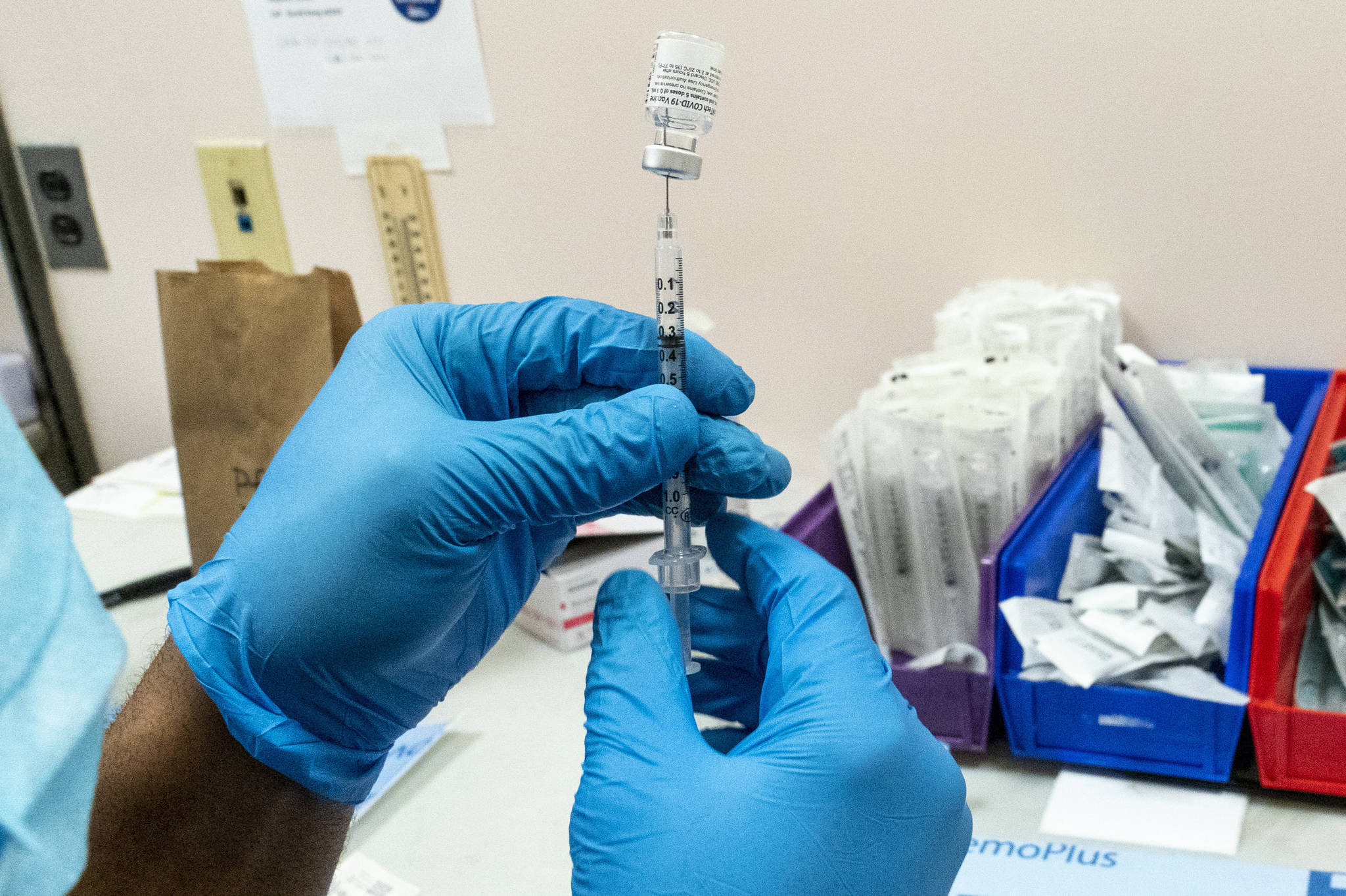 A pharmacist prepares a syringe with Pfizers vaccine at a COVID-19 vaccination site in New York. A real-world test of Pfizers COVID-19 vaccine in more than half a million people has confirmed its highly effective at preventing serious illness or death, even after one dose, according to a report released on Wednesday, Feb. 24, 2021. (AP Photo / Mary Altaffer)