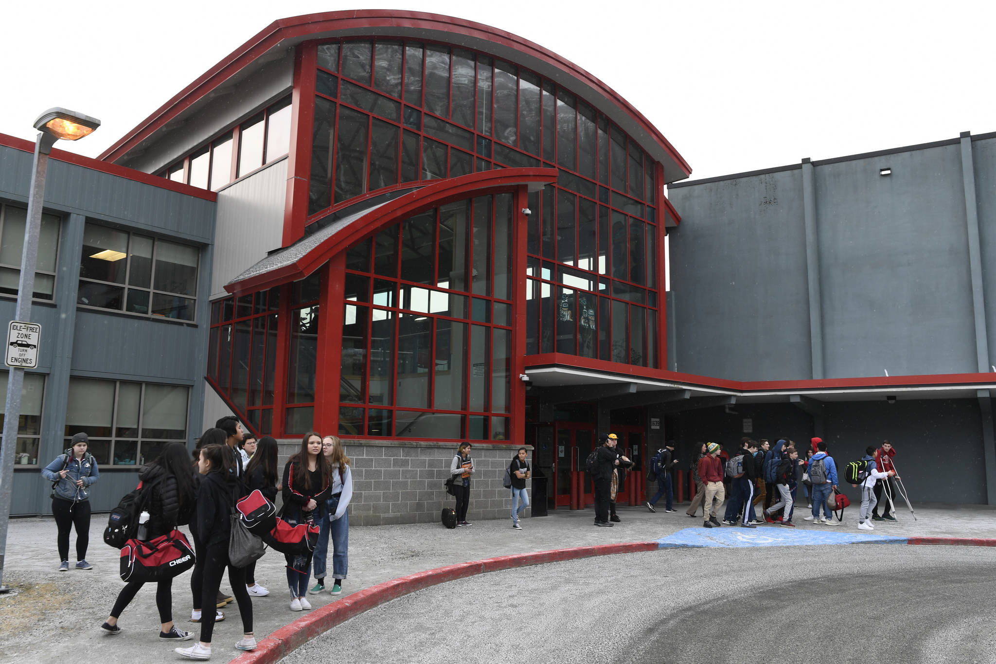 In this Feb. 2019 photo, students wait for rides outside Juneau-Douglas High School: Yadaa.at Kale. Classes will be in session this summer with programs focused on credit recovery for high school students. Children in lower grades will focus on overall learning recovery after COVID-19 upended the traditional school year and process by forcing a suspension in in-person learning. (Michael Penn /Juneau Empire File)