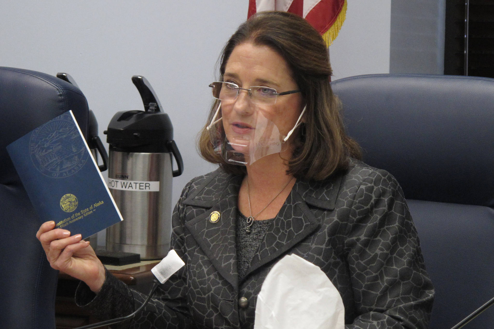 Alaska state Sen. Lora Reinbold, an Eagle River Republican, holds a copy of the Alaska Constitution during a committee hearing in Juneau, Alaska. Reinbold has been a vocal critic, along with other lawmakers, of Gov. Mike Dunleavy’s disaster declarations while the Legislature was not in session. She has used her committee to amplify voices of those who question the effectiveness of masks and the usefulness of the government’s emergency response. In a scathing letter that included references to her Facebook posts, Dunleavy accused Reinbold of misrepresenting the state’s COVID-19 response and deceiving the public. “The misinformation must end,” the governor wrote. (AP Photo / Becky Bohrer)