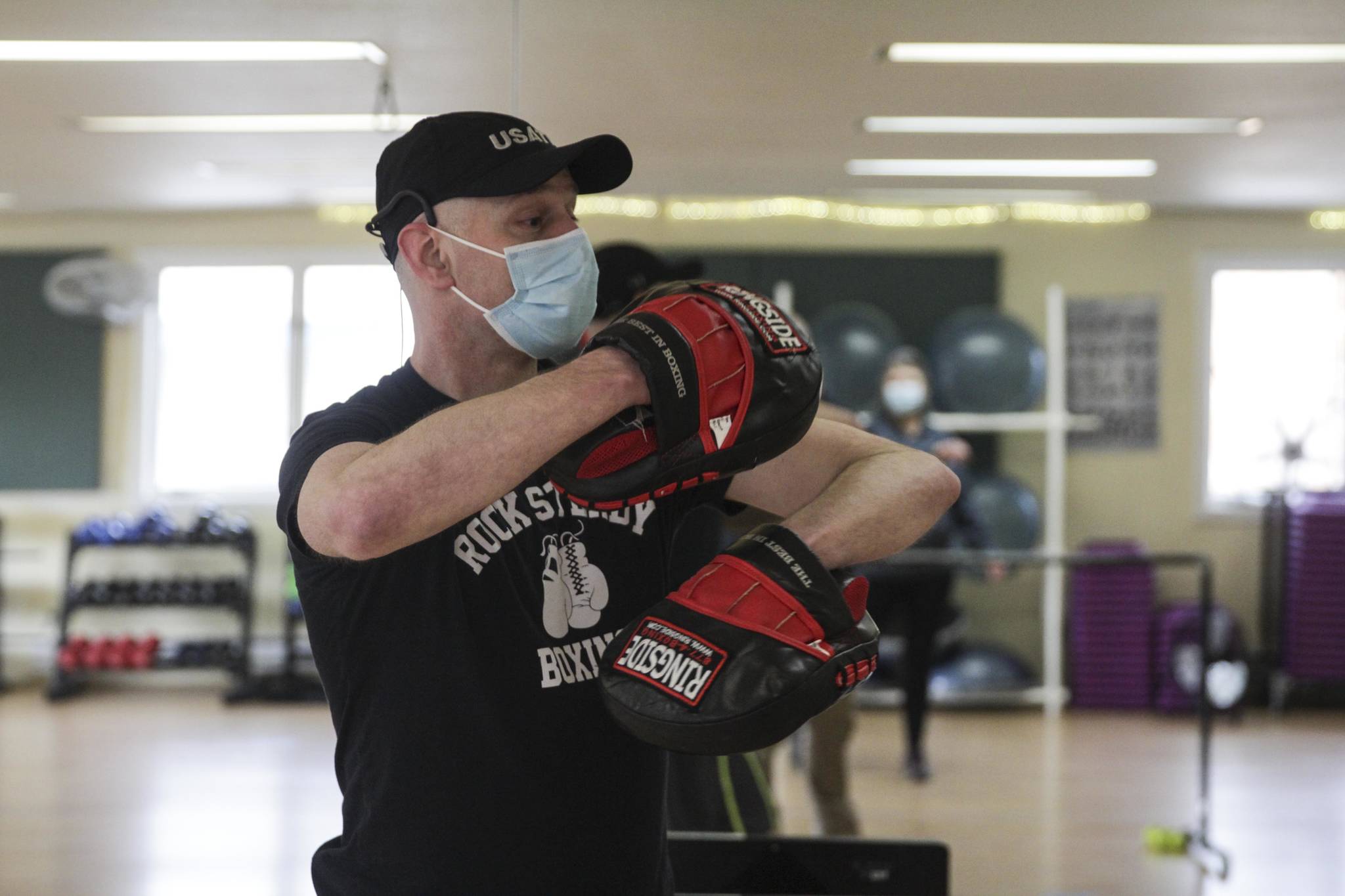 Alec Nevalainen leads a boxing class designed to help fight back against the symptoms Parkinson’s disease through a specific regimen at Pavitt Health and Fitness on March. 2, 2021. (Michael S. Lockett / Juneau Empire)
