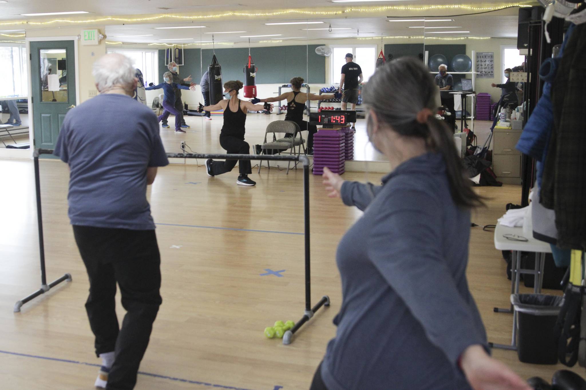 Janet Valentour, center, leads a boxing class designed to help fight back against the symptoms Parkinson’s disease through a specific regimen at Pavitt Health and Fitness on March. 2, 2021. (Michael S. Lockett / Juneau Empire)