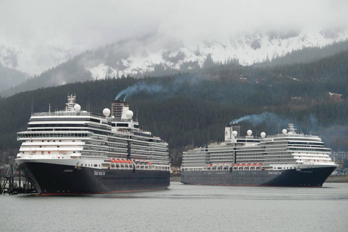 The Holland America Line cruise ships Eurodam, left, and Nieuw Amsterdam pull into Juneau’s downtown harbor on May 1, 2017. Large cruise ships are unlikely to visit Alaska this summer due to ongoing COVID-19 concerns, restrictions at the Canadian border, and a lack of sailing guidance from the Centers for Disease Control. However, in a close 5-4 vote Monday evening, the City Assembly decided to relax COVID-19-related travel mandates sooner rather than later and made other changes to make travel easier for the upcoming tourist season. (Michael Penn/Juneau Empire File)