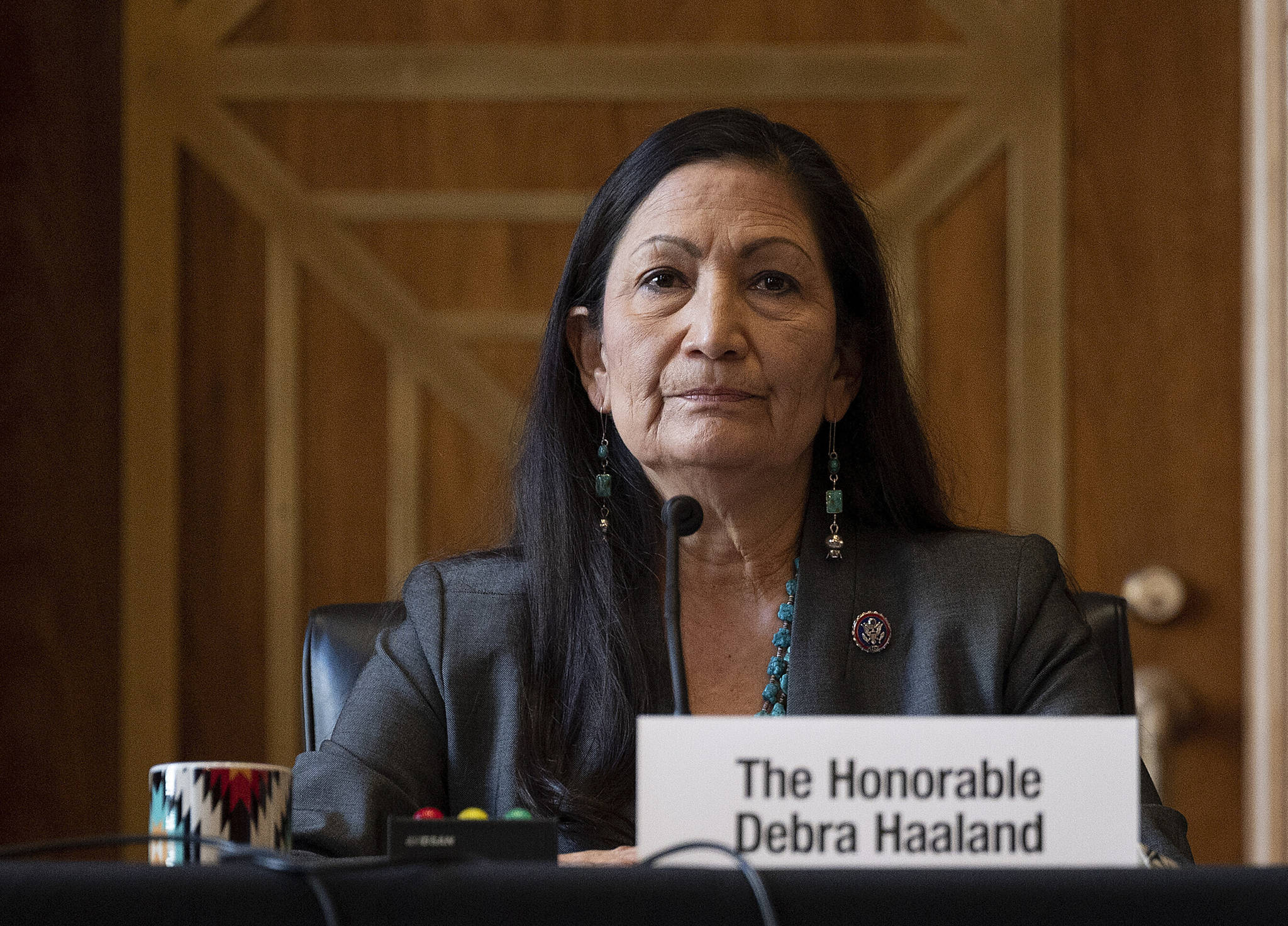 Rep. Deb Haaland, D-N.M., listens during the Senate Committee on Energy and Natural Resources hearing on her nomination to be Interior secretary, on Capitol Hill in Washington. Some Republican senators labeled Haaland “radical” over her calls to reduce dependence on fossil fuels and address climate change, and said that could hurt rural America and major oil and gas-producing states. The label of Haaland as a “radical” by Republican lawmakers is getting pushback from Native Americans. (Jim Watson / Pool Photo)