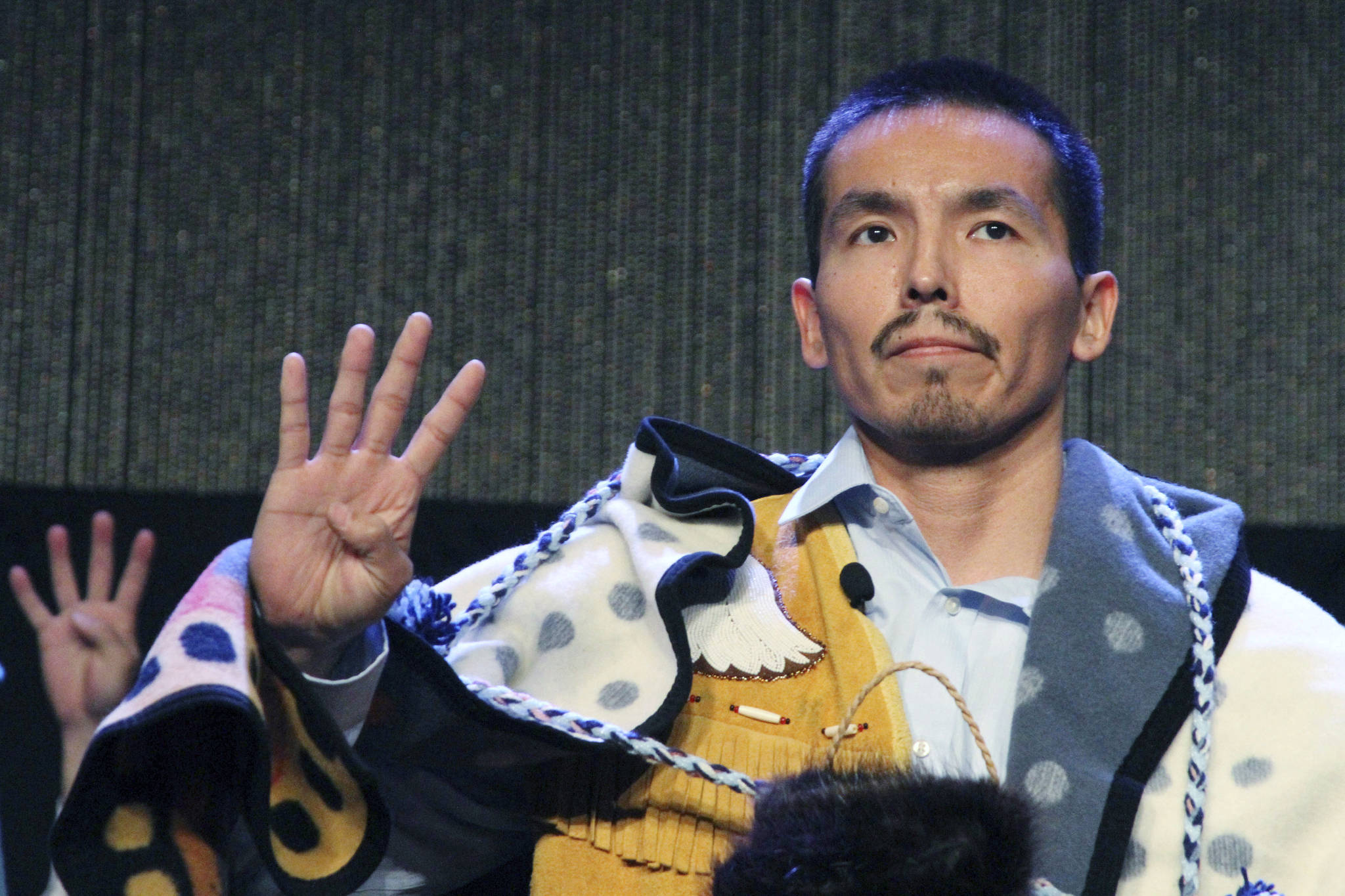 Marvin Roberts flashes four fingers in a sign of solidarity for the so-called Fairbanks Four following his address at the Alaska Federation of Natives conference in Anchorage in this 2017 photo. Roberts and three other men were convicted of killing a Fairbanks teenager in 1997. Four men who say they were illegally imprisoned for nearly two decades for the murder of a teenager in Alaska will have their lawsuit go forward after the U.S. Supreme Court declined to get involved in the case. The high court turned away the case Monday. As is typical, the justices did not comment in rejecting the case. That leaves in place a decision by the 9th U.S. Circuit Court of Appeals. In January of last year it overturned a lower court ruling that had dismissed a lawsuit by the “Fairbanks Four” against the city of Fairbanks. (AP Photo / Mark Thiessen)