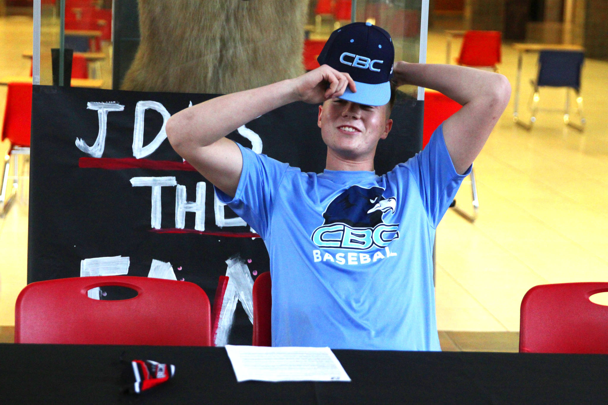 Juneau-Douglas High School Yadaa.at Kalé senior Garrett Bryant signed his letter of intent to play baseball for Columbia Basin College at JDHS on March 11, 2021. (Michael S. Lockett / Juneau Empire)