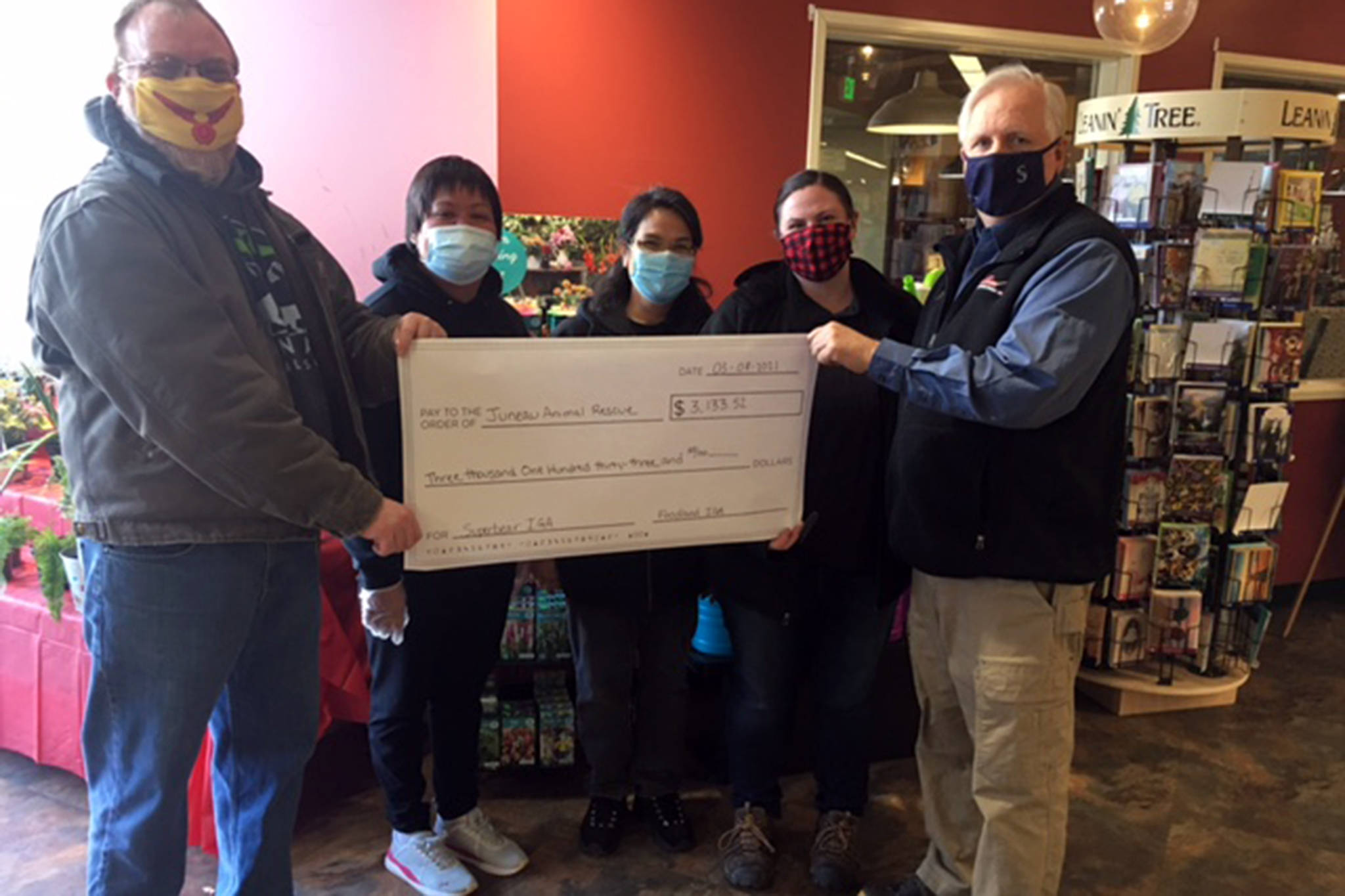Pictured are ( left to right) Shane Walker, deputy director, Juneau Animal Rescue; Christina Austin, Foodland casher; Cecilia Watson, Foodland cashier; Kelly Crow, Super Bear store director; and Rick Wilson, Foodland store director (Courtesy Photo)