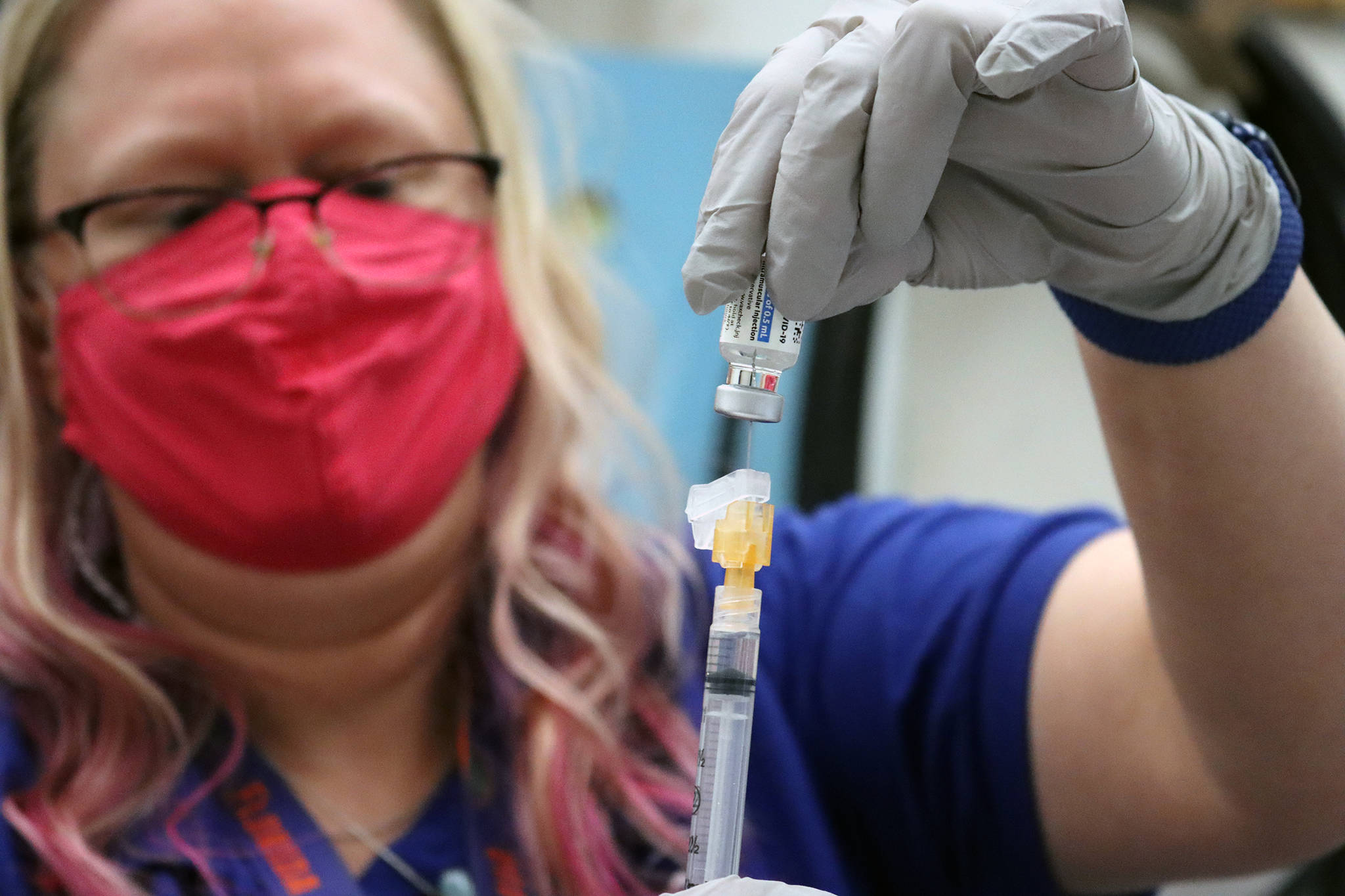 Sandi Eldridge, pharmacist for the Department of Veterans Affairs, draws a dose of Johnson & Johnson vaccine at a vaccine clinic at Coast Guard Station Juneau on March 13, 2021. (Ben Hohenstatt / Juneau Empire)