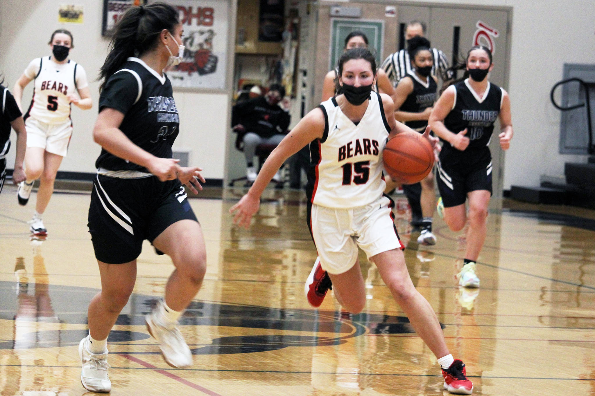 Jenae Pusich pushes the ball down the court for Juneau-Douglas High School Yadaa.at Kalé in a crosstown clash with Thunder Mountain High School on March 5, 2021. (Ben Hohenstatt / Juneau Empire)