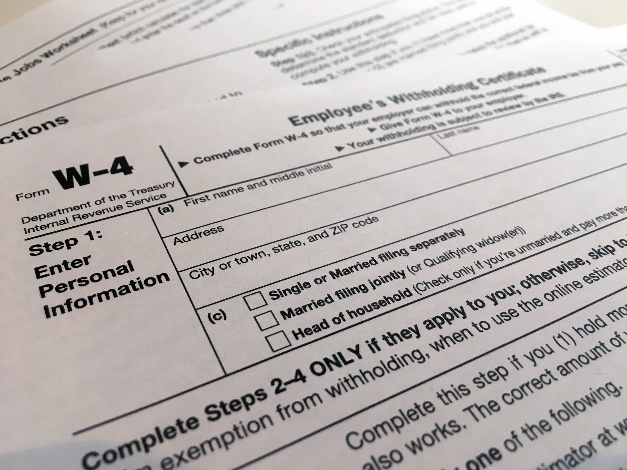 In this February 2020 photo, a W-4 form is viewed in New York. The IRS will delay the traditional April 15 tax filing due date until May 17, 2021, to cope with added duties and provide Americans more flexibility. (AP Photo / Patrick Sison)