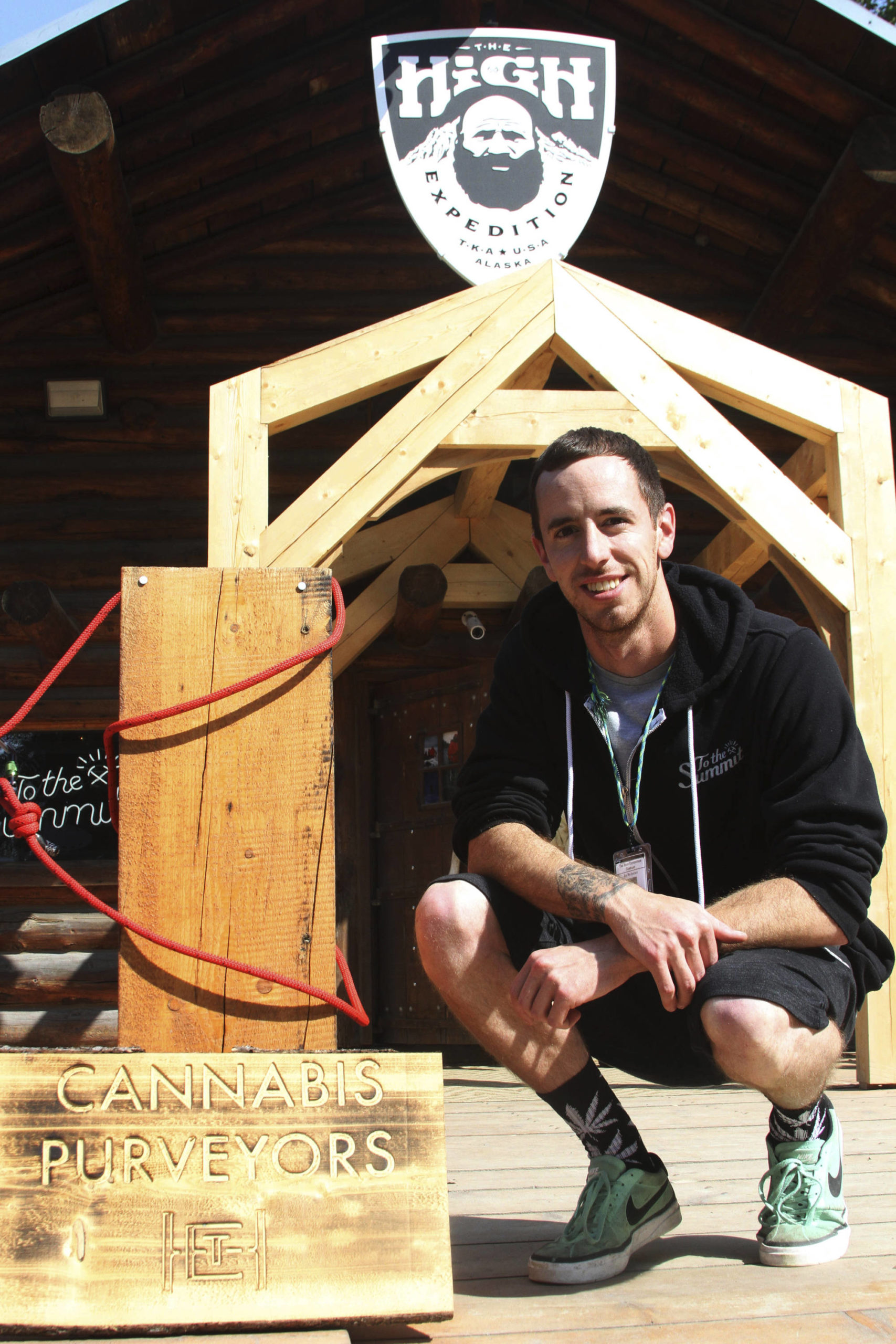In this July 12, 2017, file photo, co-owner Joe McAneney poses for a photo in front of The High Expedition Co. in Talkeetna, Alaska. Regulators amid much fanfare in early 2020 approved the first cannabis lounges in Alaska. It was a milestone for the state’s legal marijuana industry. Then the pandemic hit. An owner of one of the shops hopes to open later this year. An owner of the other said his shop opened briefly last fall before having to hit pause amid a surge in COVID-19 cases across the state. (AP Photo / Mark Thiessen)