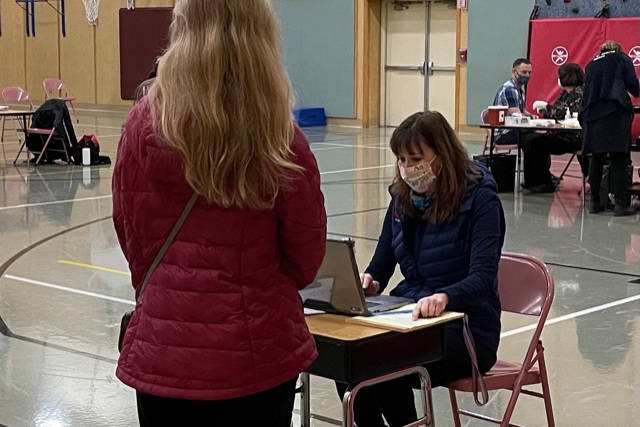 Juneau School District Superintendent Bridget Weiss checks someone in during a vaccine clinic held at a school district facility. The district will hold in-house clinics for any Juneau resident between 16 and 18 on April 9. (Courtesy photo / Juneau School District)