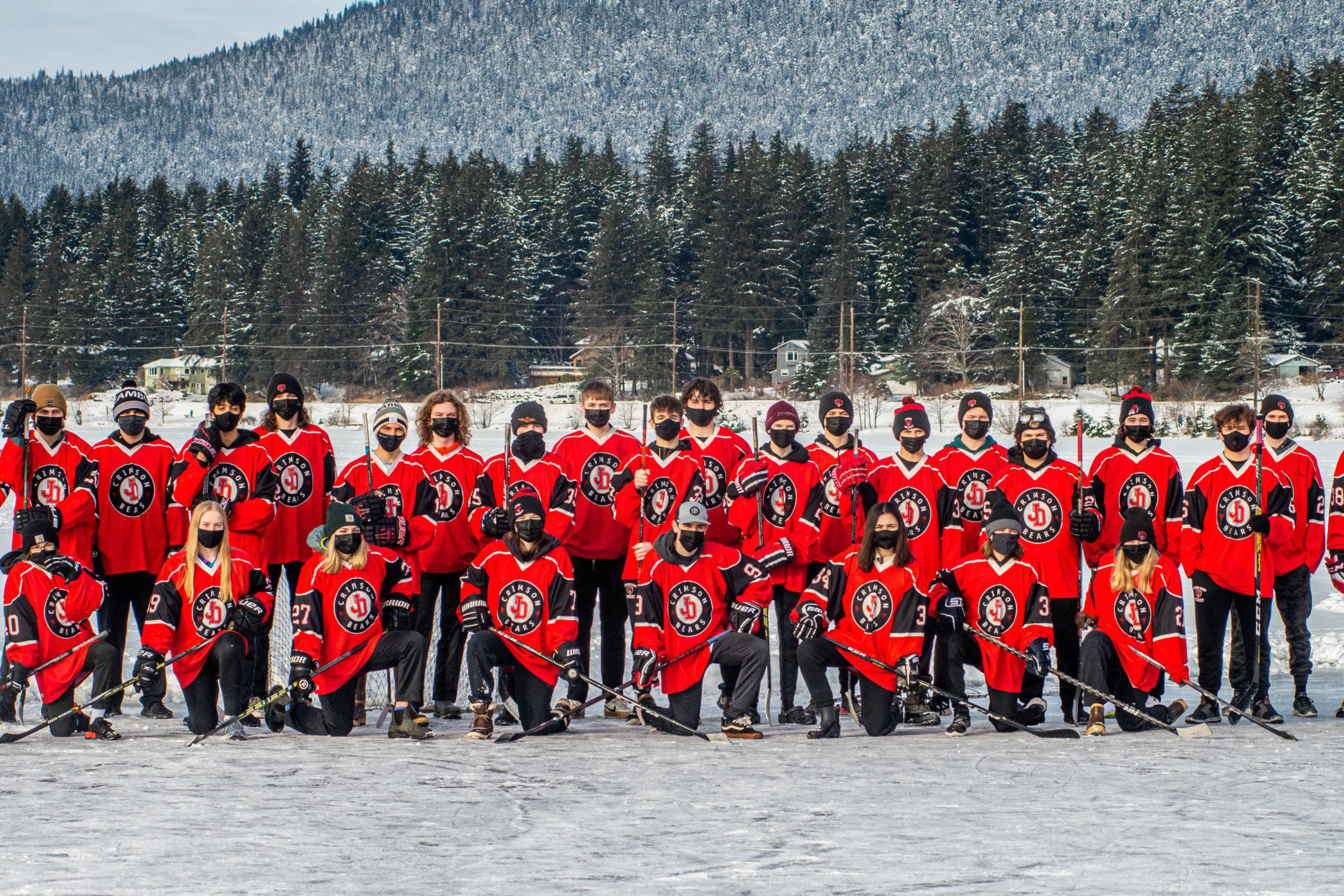 The Juneau-Douglas High School: Yadaa.at Kalé Crimson Bears hockey team, posing here for a team photo at Twin Lakes, went through a gameless season in 2021, with all travel curtailed by the coronavirus. (Courtesy photo / Steve Quinn)