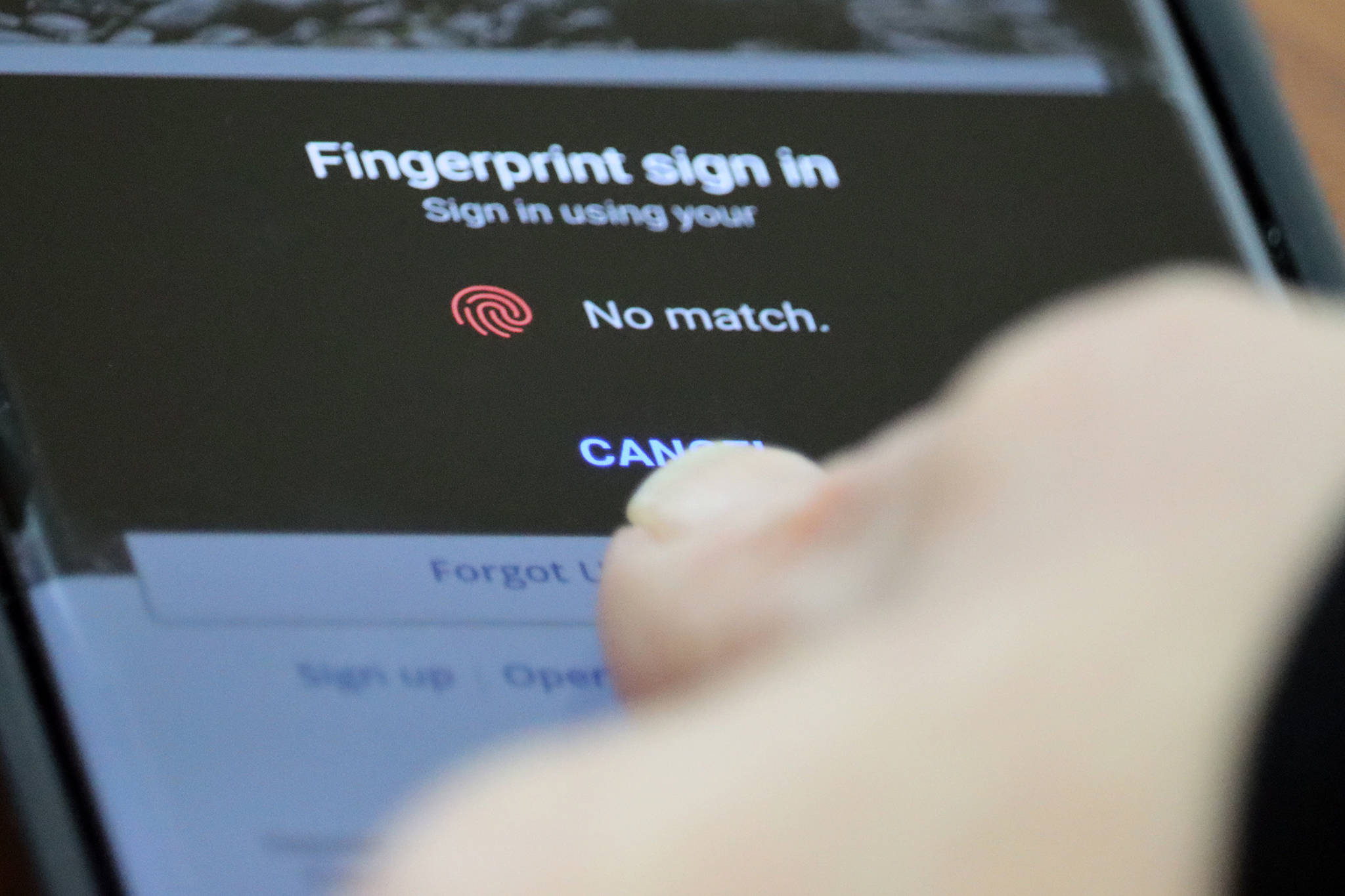 A person holds their thumb over a fingerprint sensor to log into an application. Gov. Mike Dunleavy on Wednesday introduced a bill that would make companies that collect and sell private information have to receive user’s consent first. (Ben Hohenstatt / Juneau Empire)