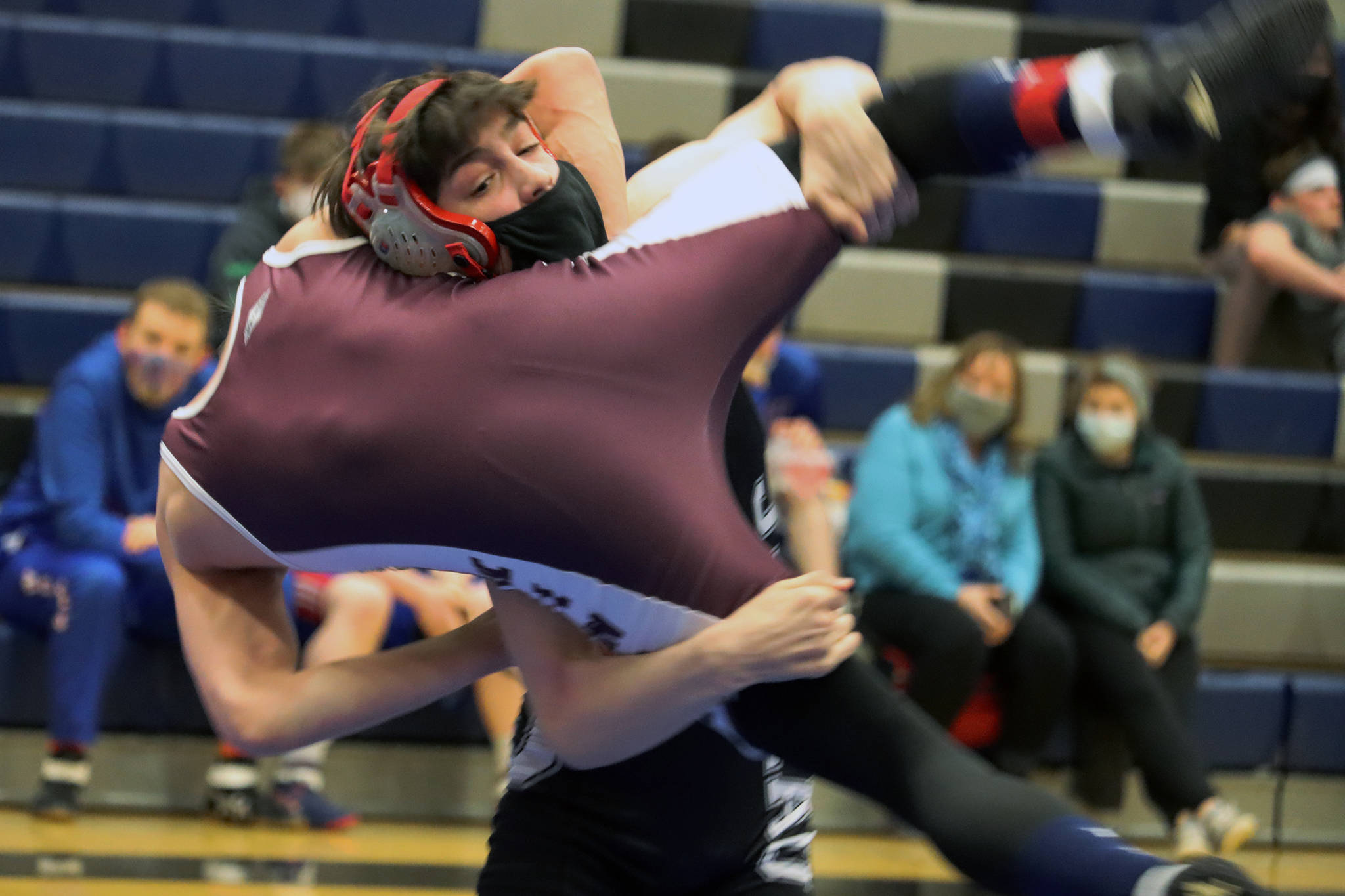 Carson Cummins hoists his opponent from Ketchikan High School before taking him to the mat during a tournament at Thunder Mountain High School on Friday, April 3. Cummins went undefeated during the tournament and took first place in the 112-pound division. (Ben Hohenstatt / Juneau Empire).