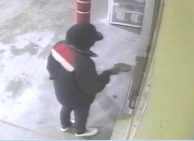 The Juneau Police Department are seeking a man, seen here in security footage, involved in the robbery of the Safeway fueling station early Sunday morning. (Courtesy photo / JPD)