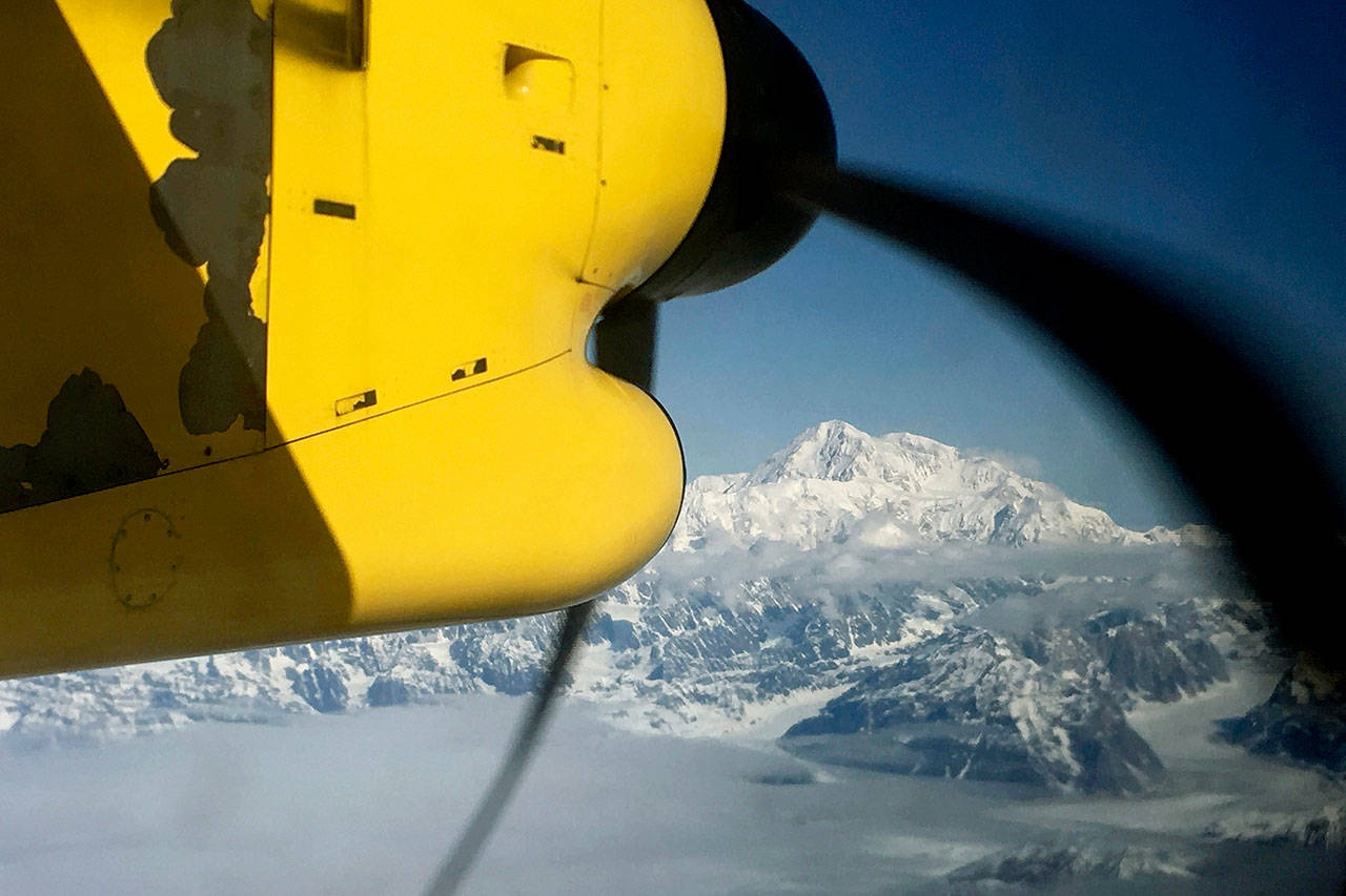 Denali, North America’s tallest peak, from an airplane flying over the Alaska Range near Talkeetna. Officials on Monday said five people had to ski through a snowstorm to a shelter after they landed on Ruth Glacier at the base of Denali. (AP Photo/Mark Thiessen, File)