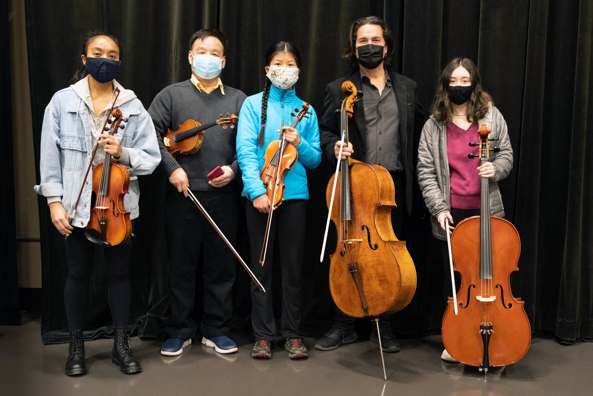 The city's COVID-19 vaccine clinics at Centennial Hall are now Juneau's premier concert venue. On April 3, local strings group Dynamics followed Grammy-award-winning cellist, Zuill Bailey in a live concert at the clinic. Jayda Skeek, far left, musical coach and teacher Guohua Xia second to the left, students Jin Yue Trousil and Creys Hudson flank Bailey from left to right. (Courtesy Photo / Jim Pfitzer)