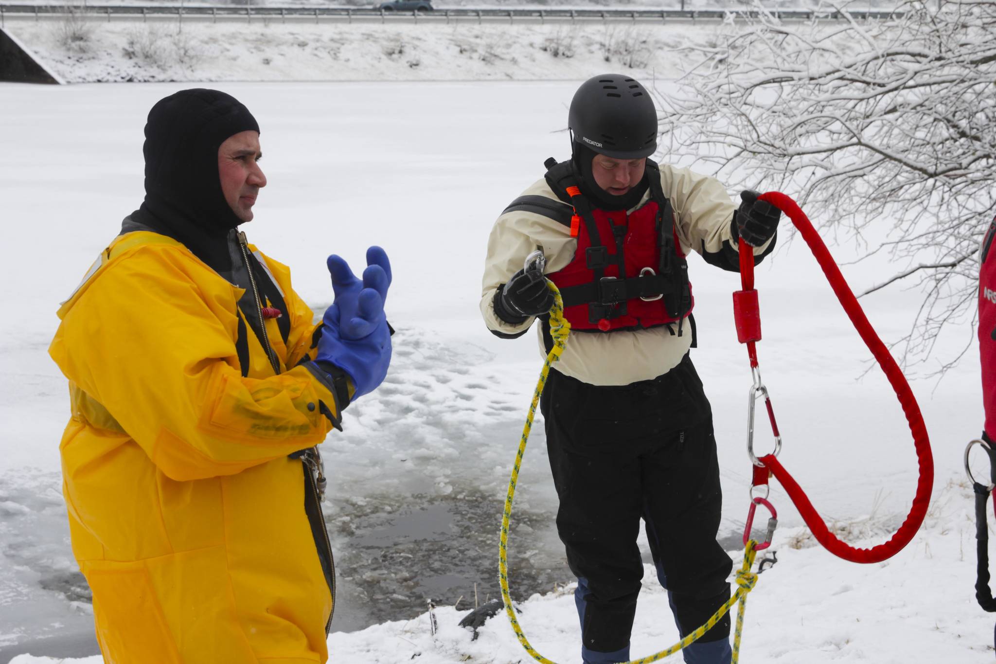 Capt. Jayme Johns, in yellow, head of the Capital City Fire/Rescue’s water rescue team, and Brady Fink, one of the trainers, get kitted up during CCFR’s annual ice rescue training at Twin Lakes on April 7, 2021. (Michael S. Lockett / Juneau Empire)