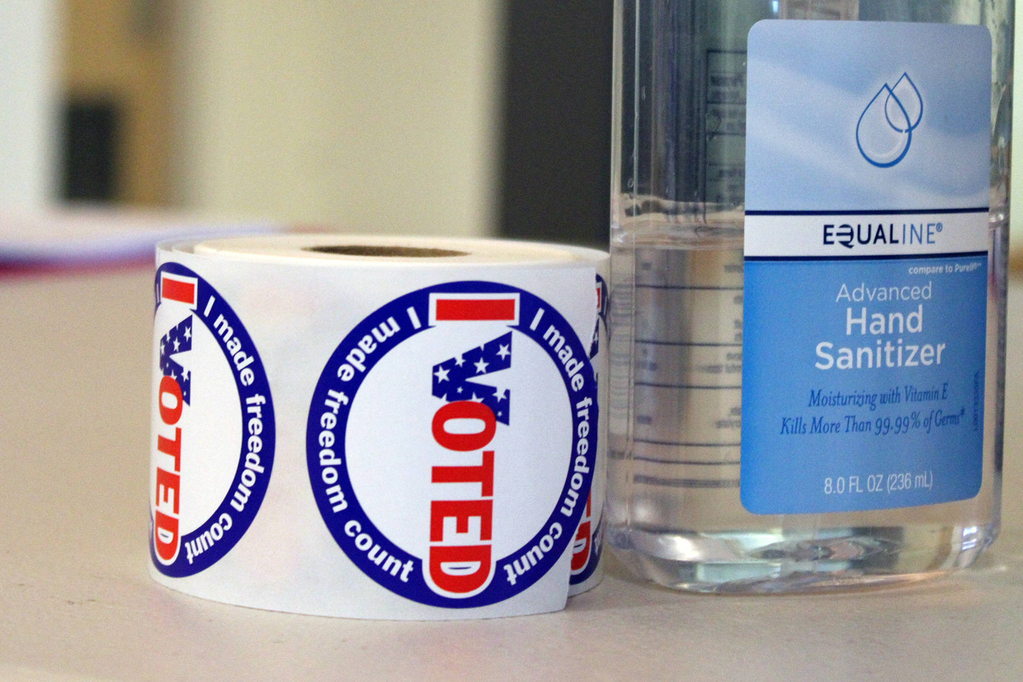 A role of "I Voted" stickers sit sanitizer. (Ben Hohenstatt / Juneau Empire File)