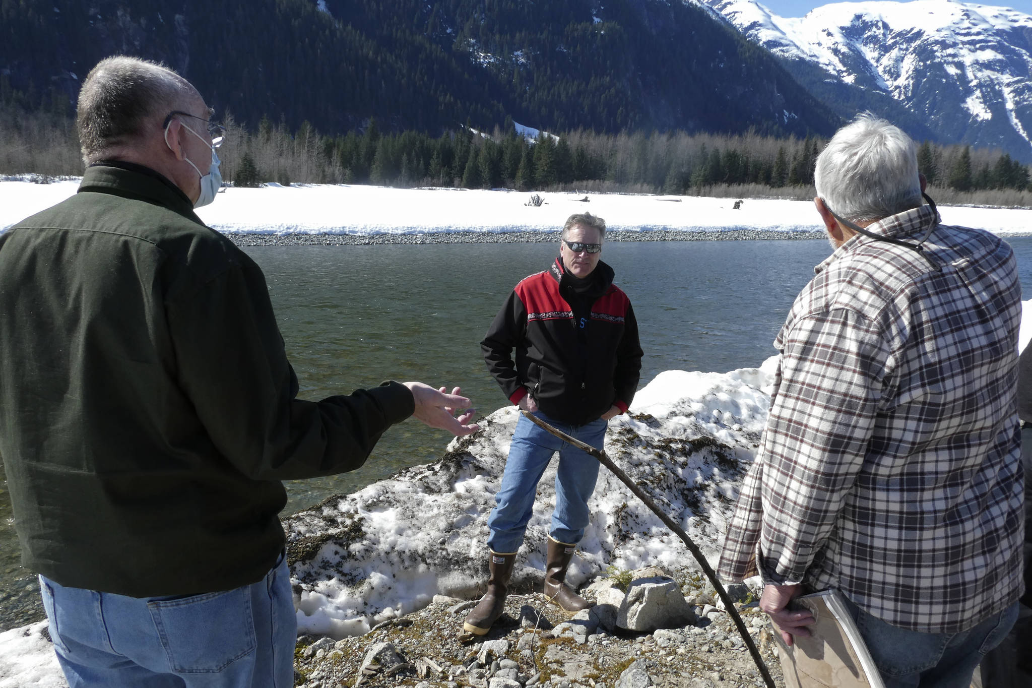 Alaska Gov. Mike Dunleavy, center, listens as residents discuss a levee they have concerns with on Thursday, April 22, 2021, in Hyder, Alaska. Hyder was among the Southeast Alaska communities that Dunleavy visited as part of a one-day trip. (AP Photo / Becky Bohrer)